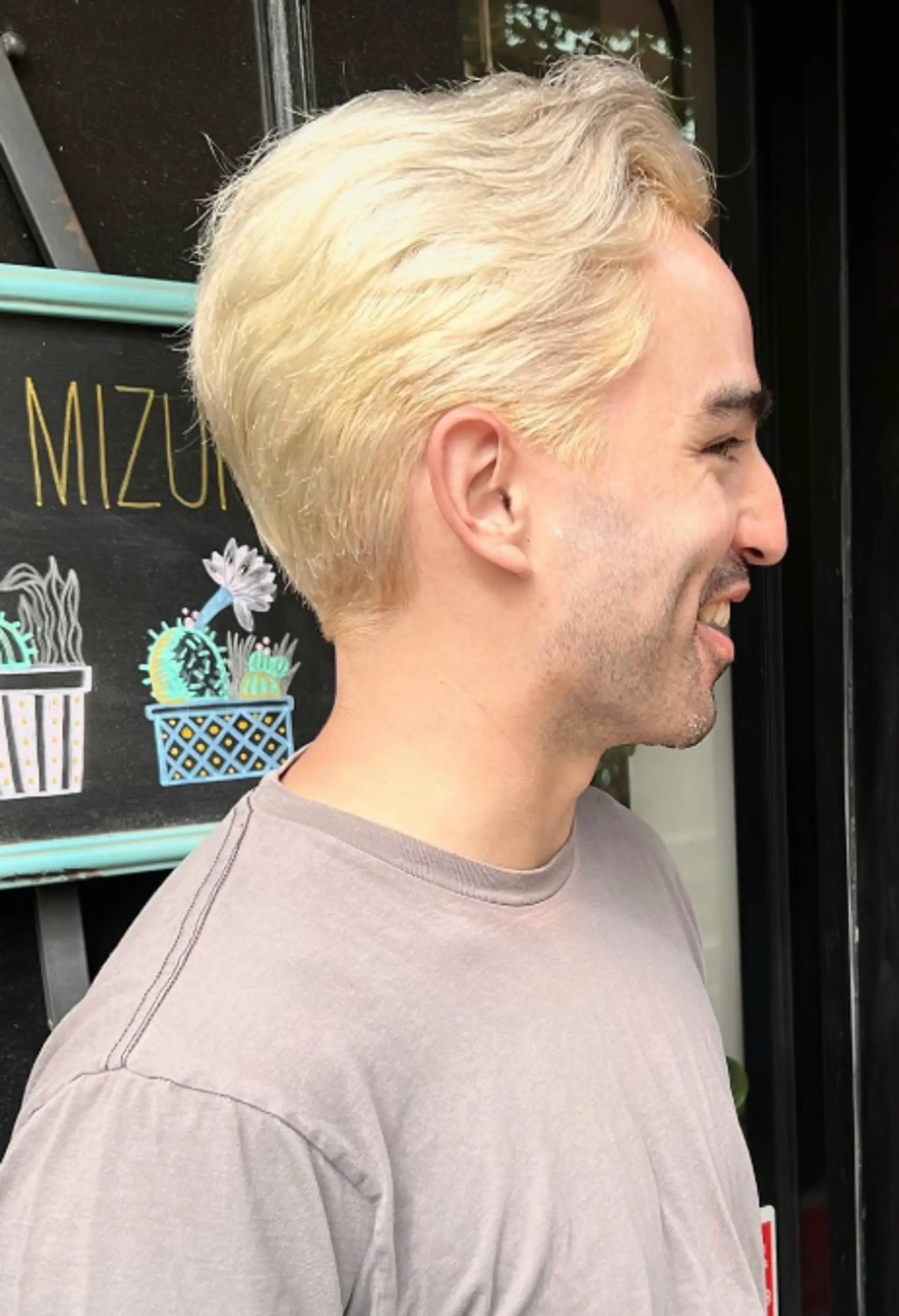 A short, textured hairstyle with a wavy top. 1