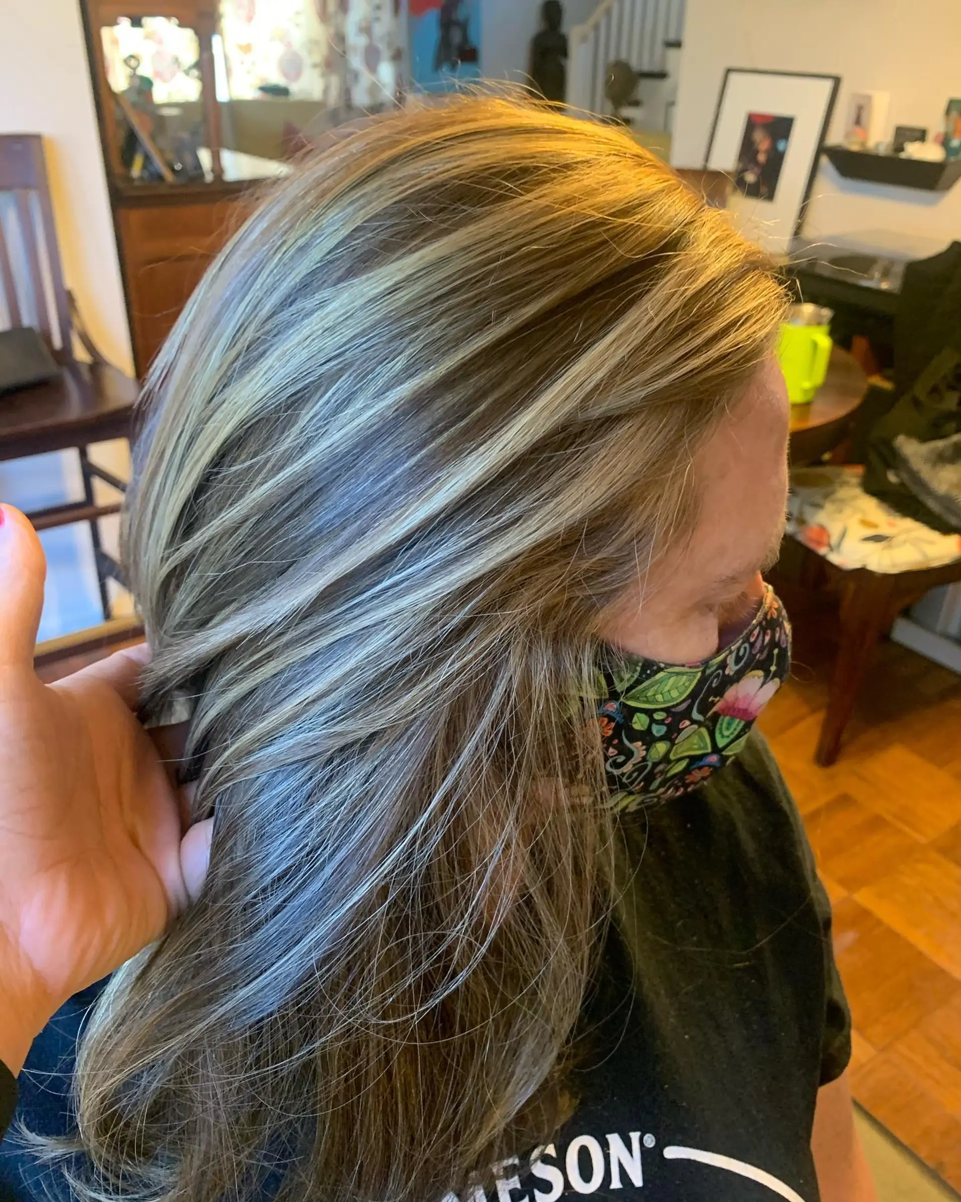 Medium-length light brown hair detailed with cool-toned blonde highlights to create seamless dimensional texture. 1