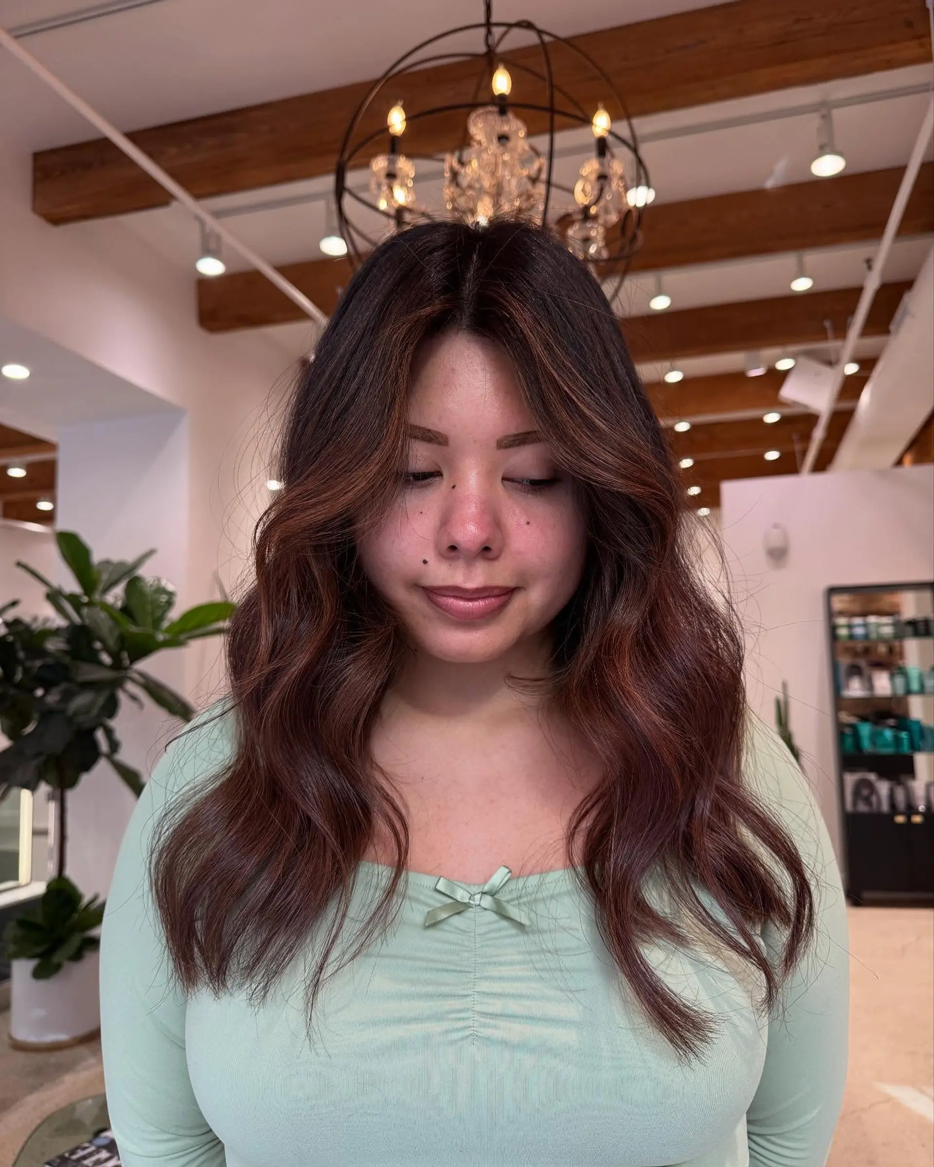 Long wavy hairstyle with face-framing layers and subtle highlights. 1