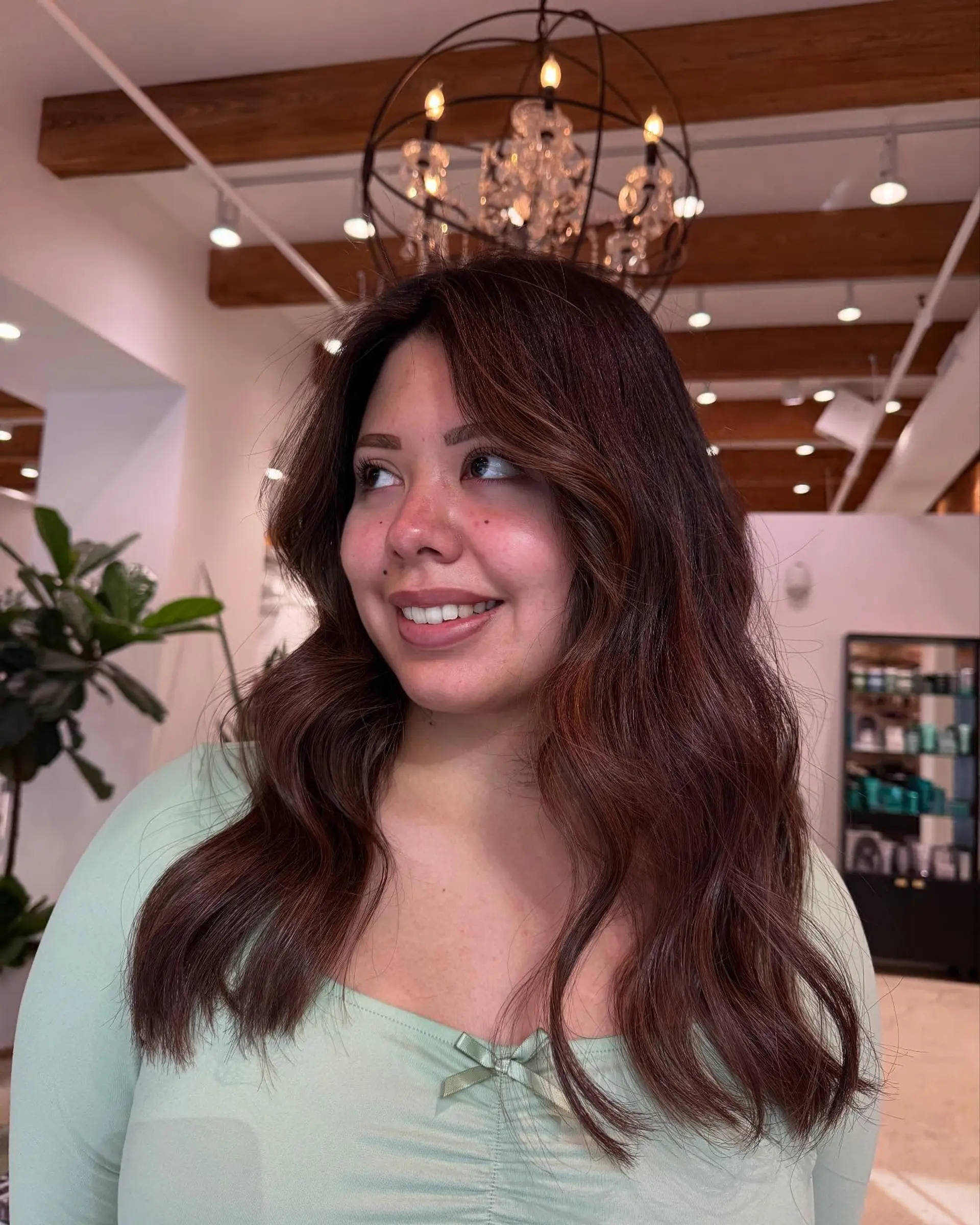 Long wavy hairstyle with face-framing layers and subtle highlights. 2