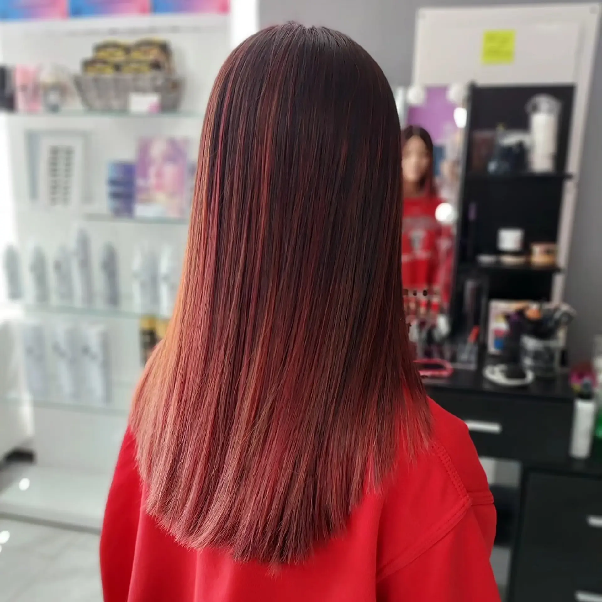 Straight, smooth mid-back length hair with a soft V-shape cut and a dark-to-red ombre color blend. 1