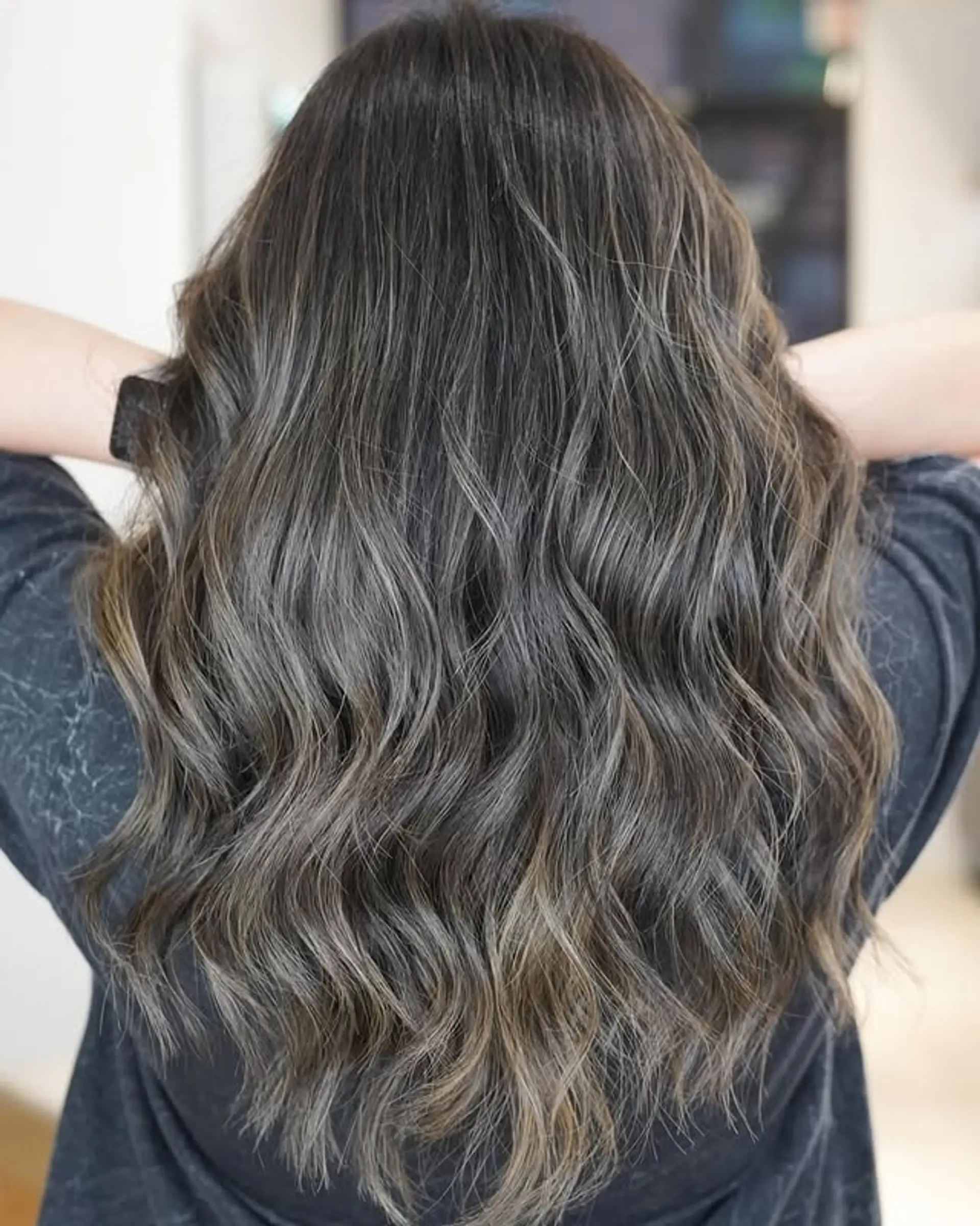 Long wavy hairstyle with ash brown and silver balayage highlights. 1