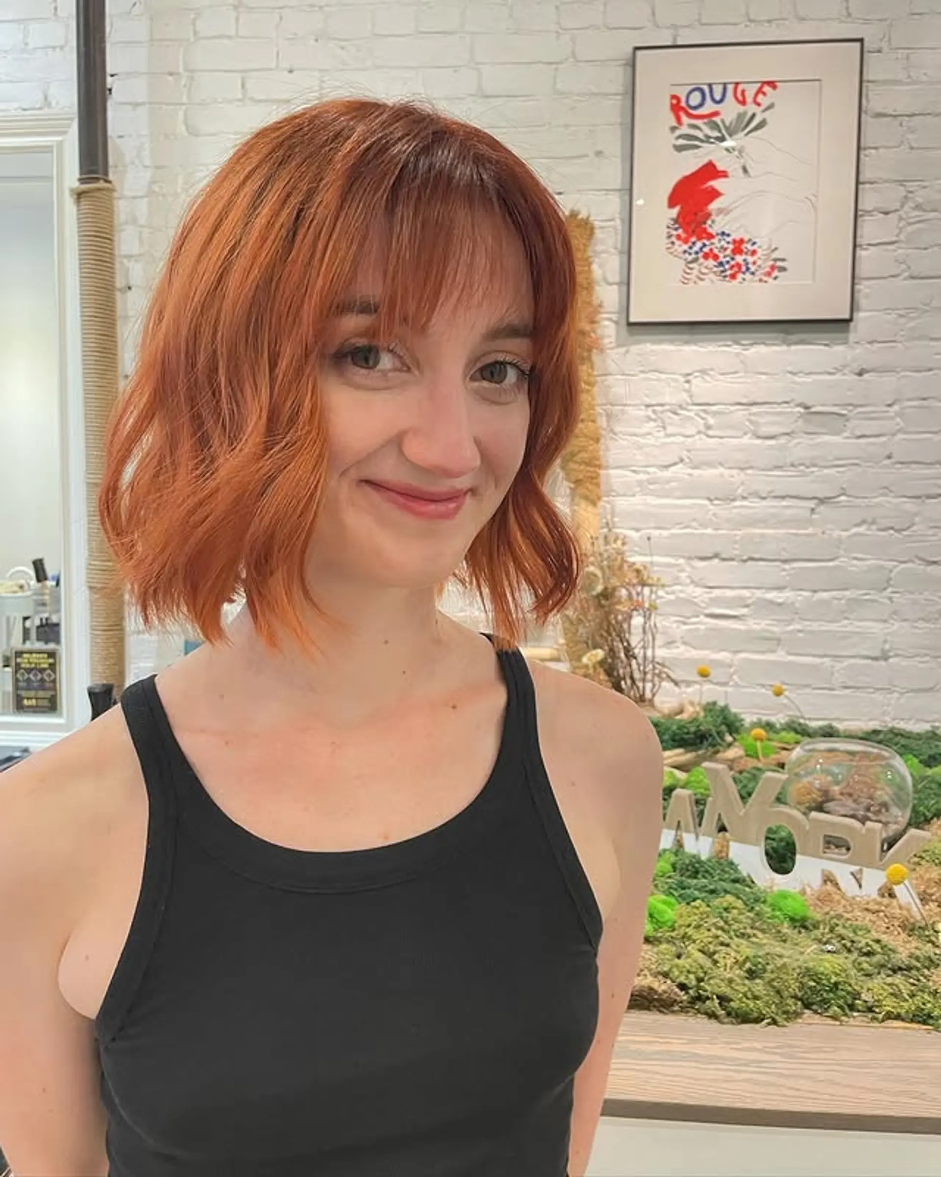 A medium wavy bob with face-framing bangs. 1