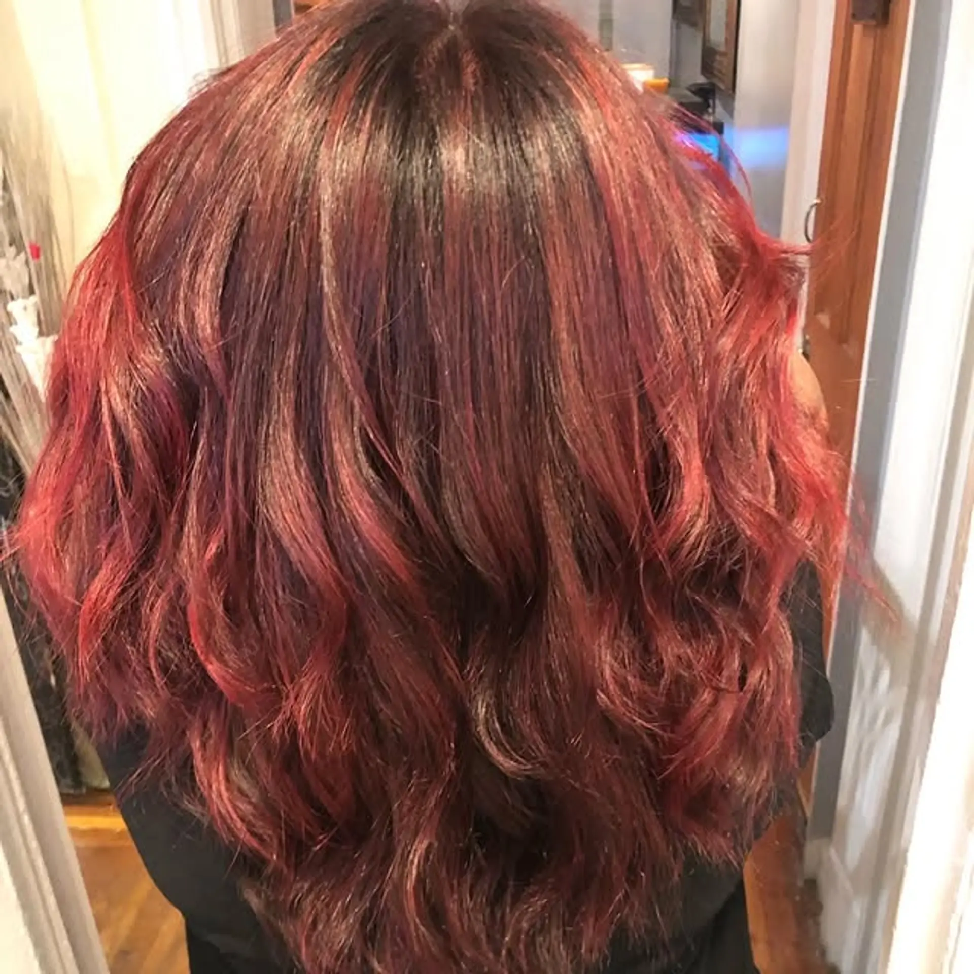 Long wavy hair with a burgundy balayage. 1