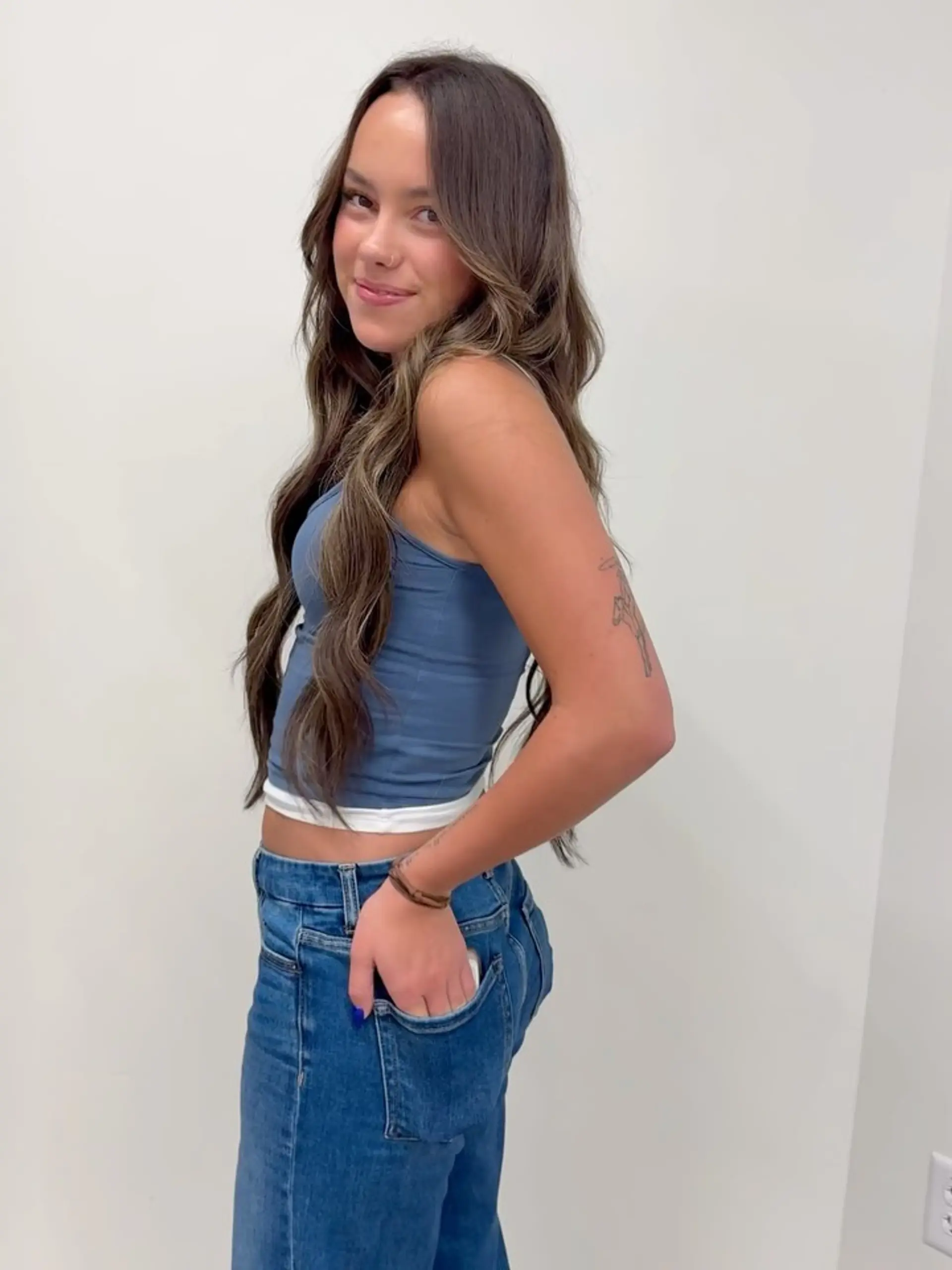 Very long dimensional brunette hair styled into soft, effortless waves. 1
