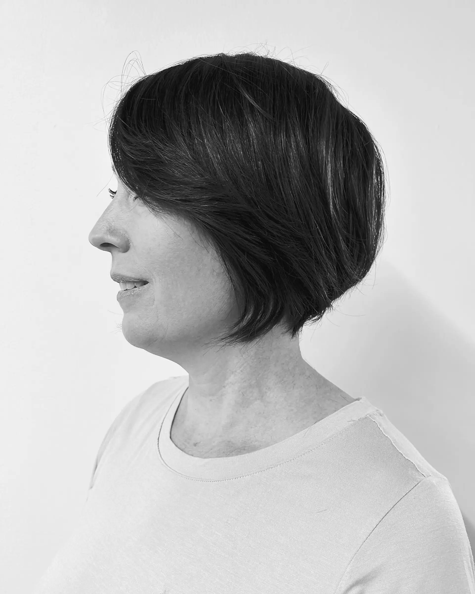 A short, rounded bixie haircut with soft layering and side-swept fringe. 1