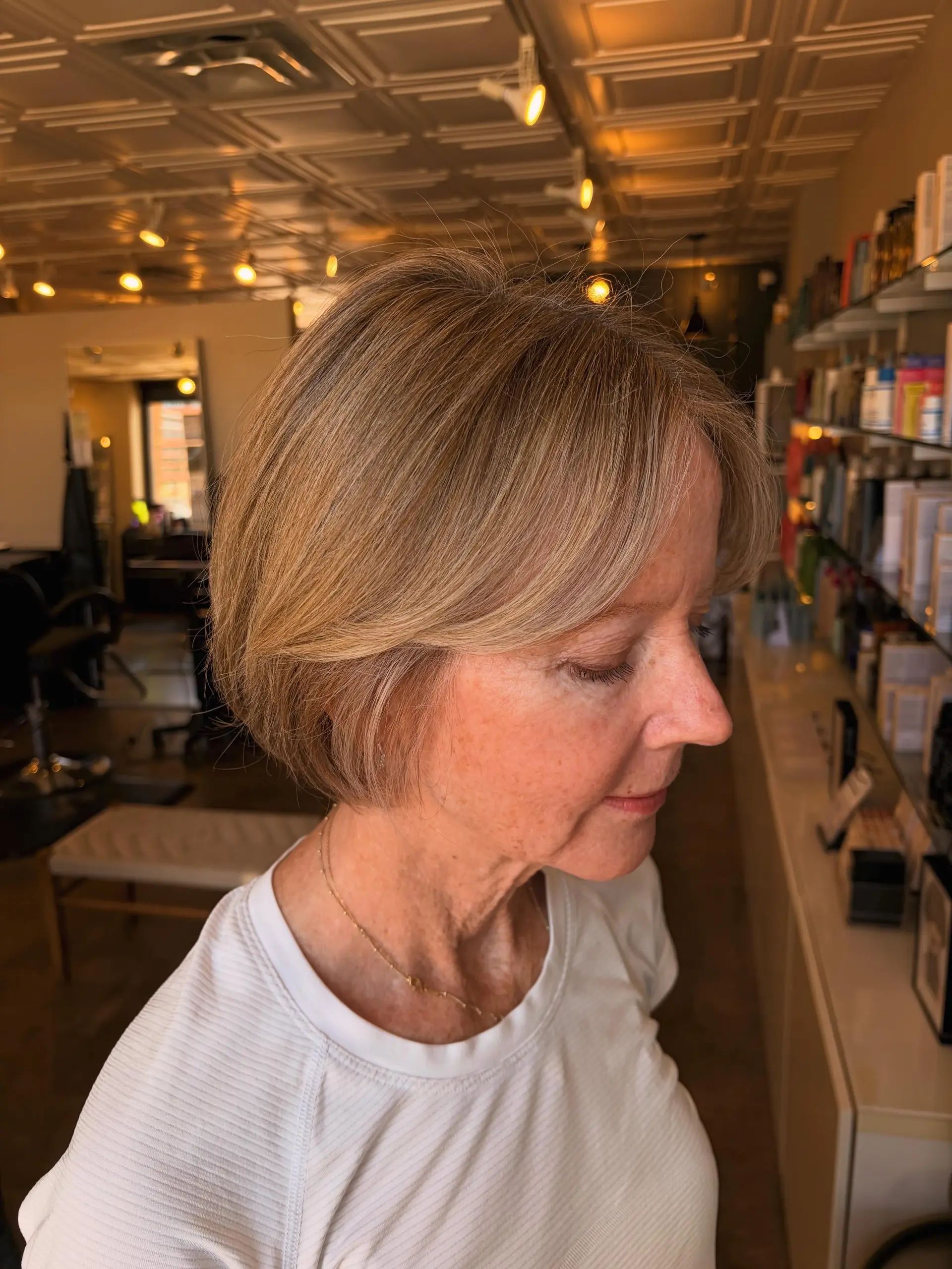 A soft, textured chin-length bob cut paired with seamless, blended dimensional blonde highlights. 1