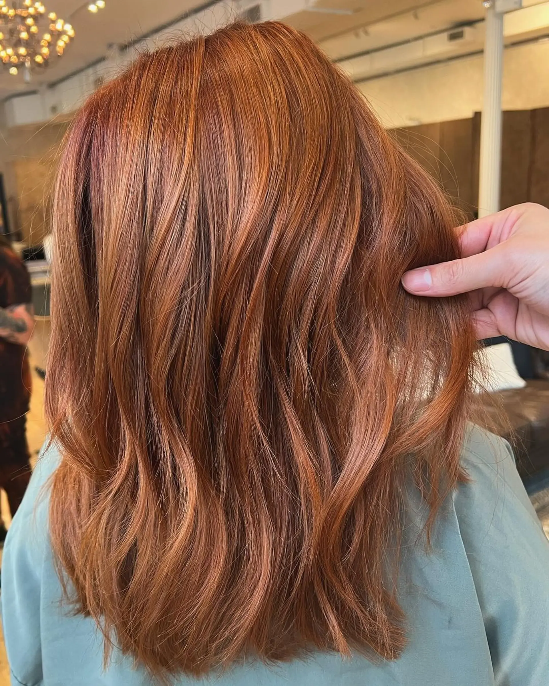 Medium-length, wavy hair with a blend of auburn and copper colors, featuring loose and natural waves.

Stylist: @danieldoeshair 1