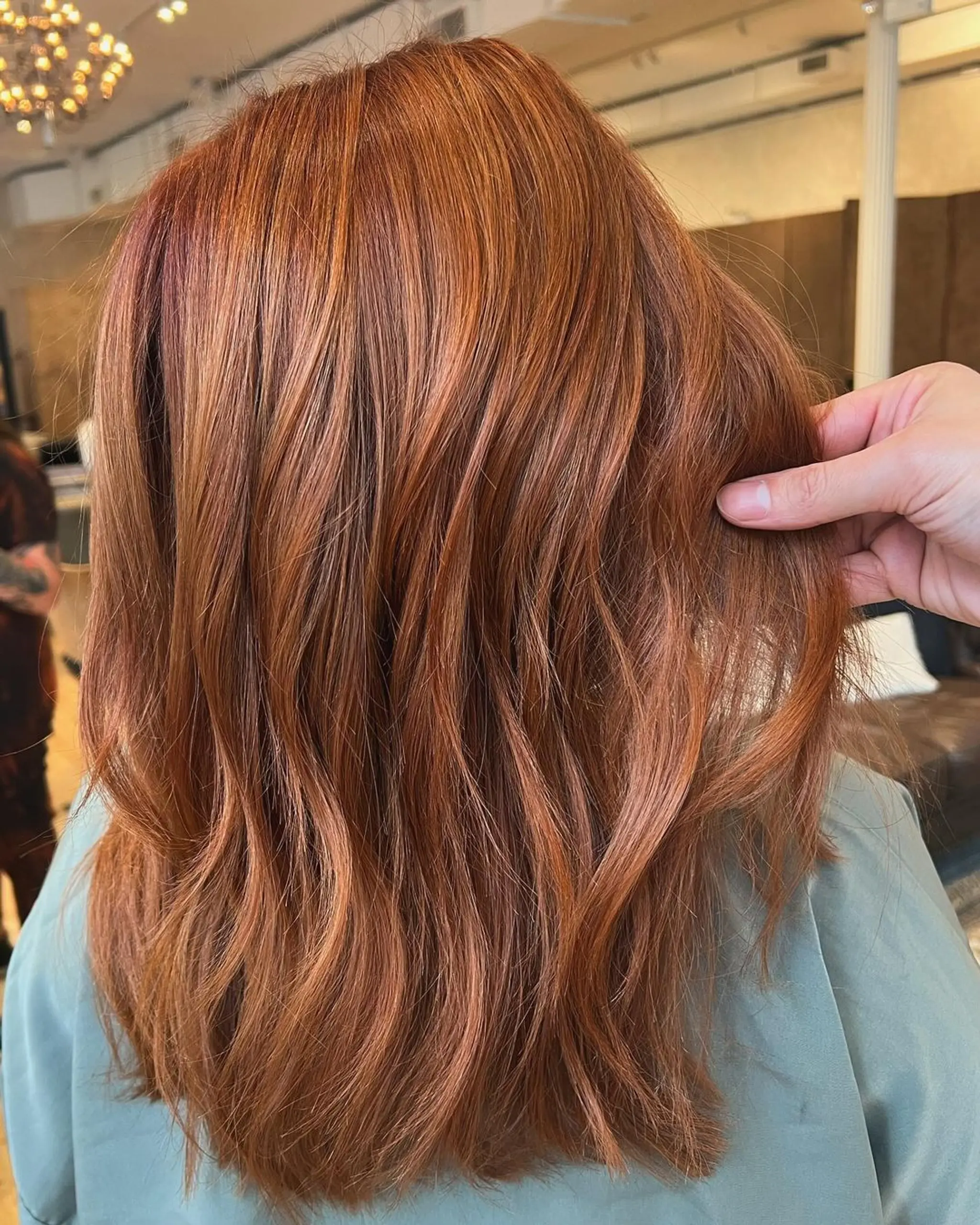 Medium-length, wavy hair with a blend of auburn and copper colors, featuring loose and natural waves.

Stylist: @danieldoeshair