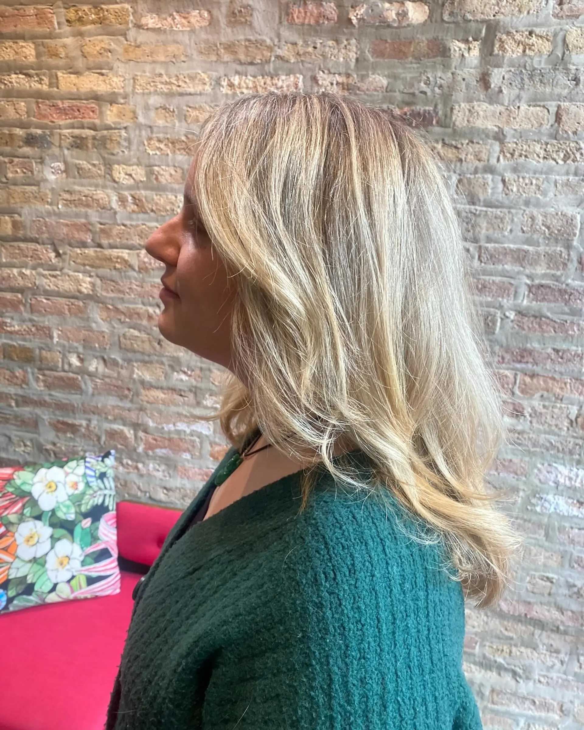 A medium length layered hairstyle with bronde balayage highlights. The textured layers create movement and a beachy wave effect. 1