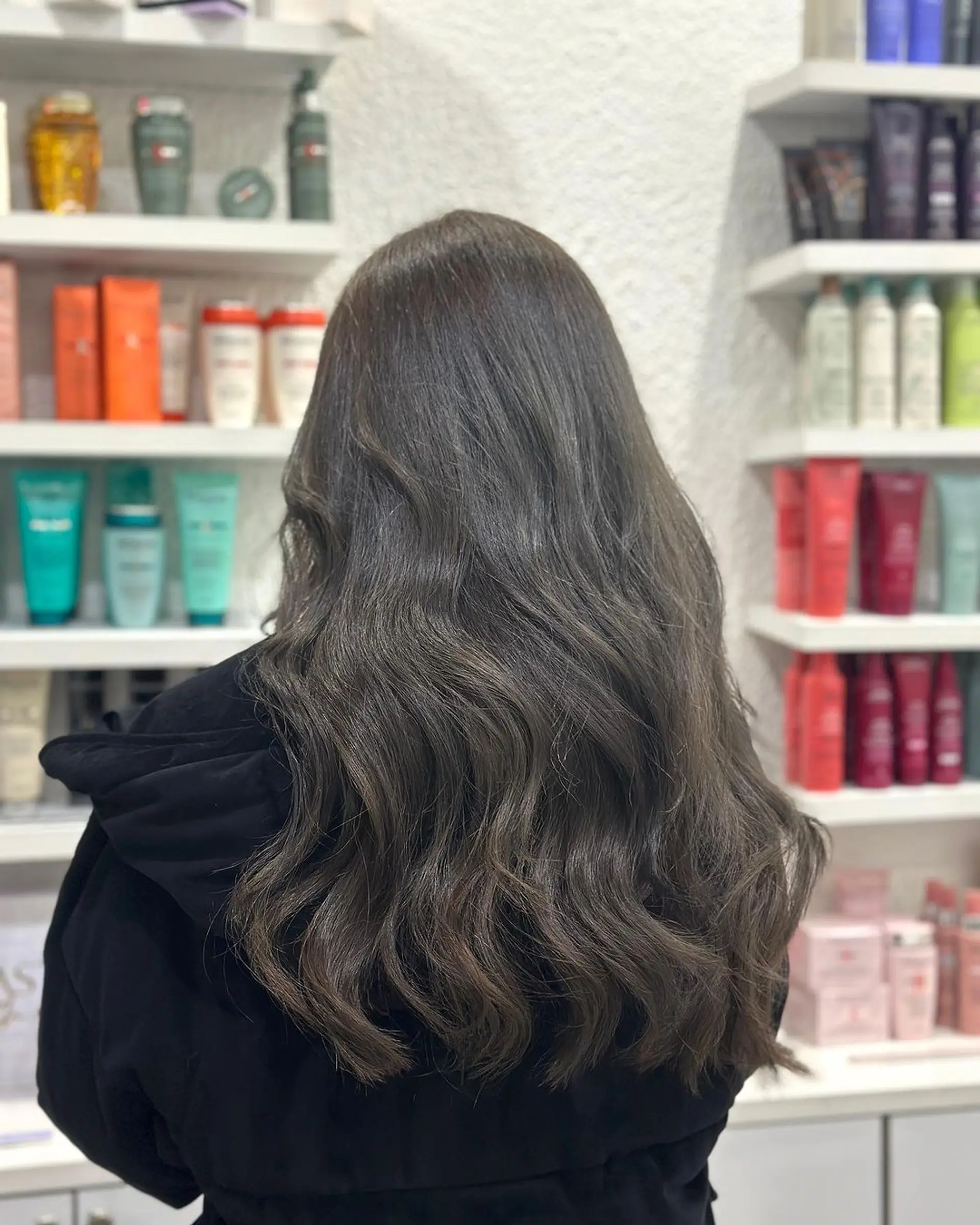 Long, wavy ash brown hair with soft, layered waves and natural shine, creating a voluminous and textured look. 2