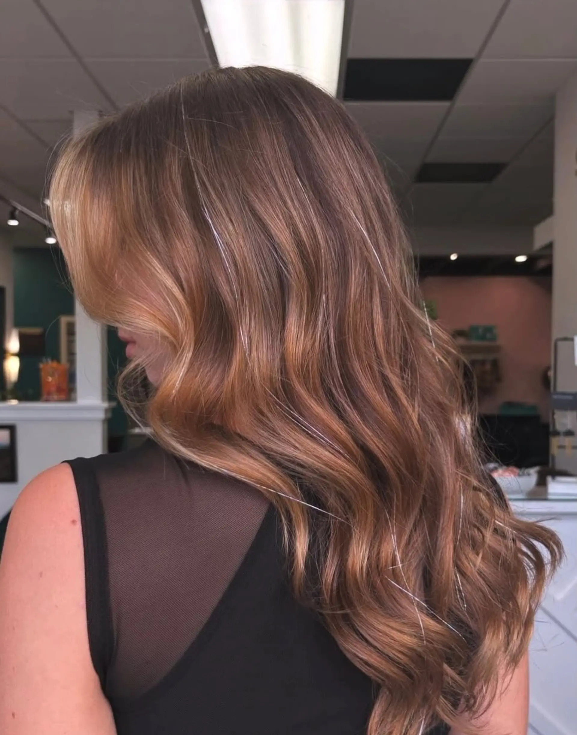 Long, flowing caramel brown hair styled in soft voluminous waves, accented with sparkling silver hair tinsel strands and a face-framing lighter layer. 1