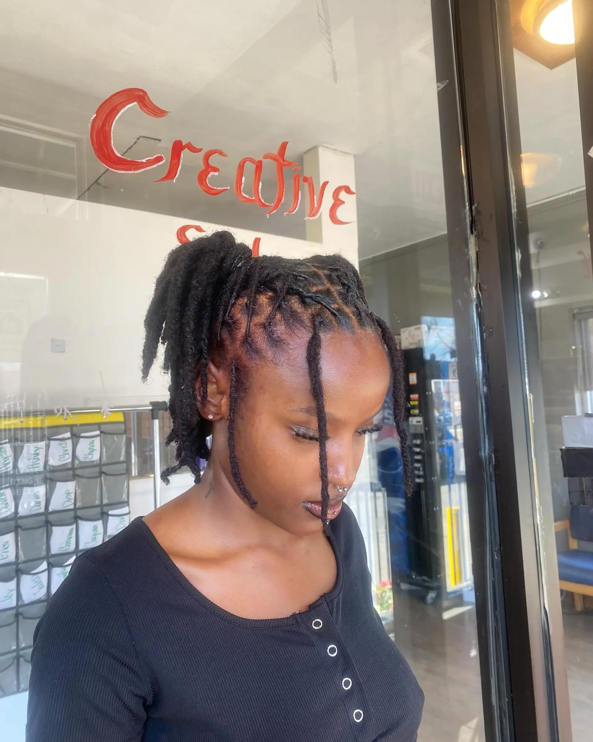 Protective locs styled into a ponytail with a braided base. 1