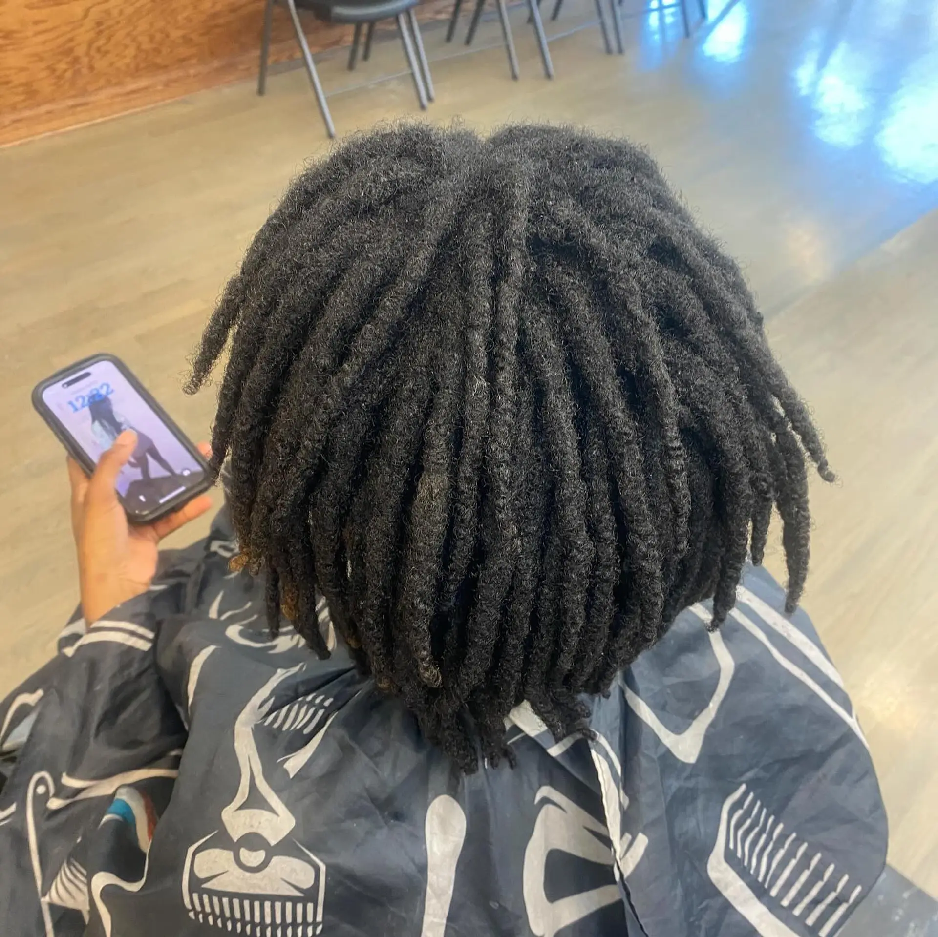 Protective locs styled into a ponytail with a braided base. 3