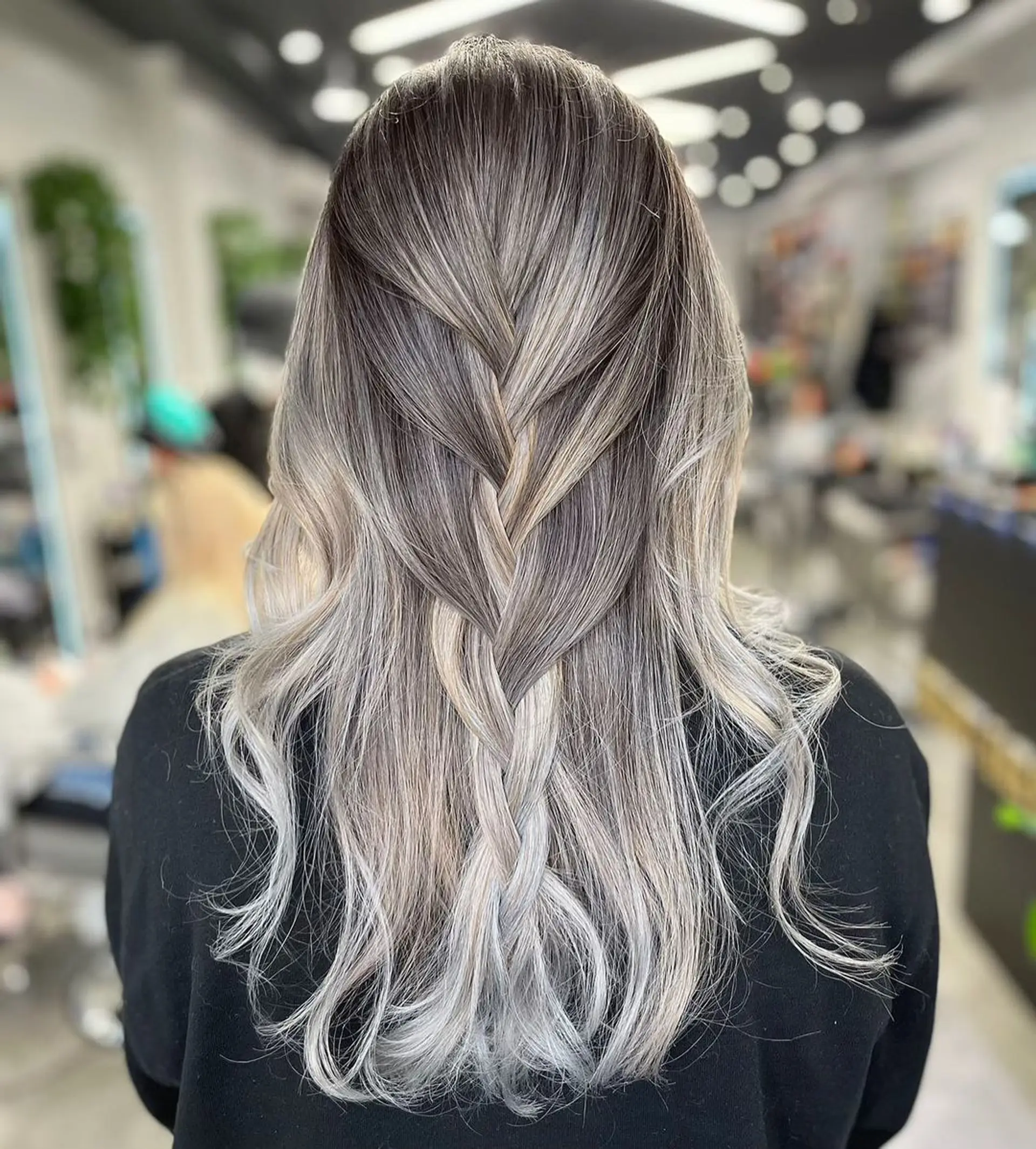 Long, wavy hair with a braided crown and an ombre effect transitioning from silver at the roots to blonde-silver towards the ends.
Stylist - @xcellent_jason 1