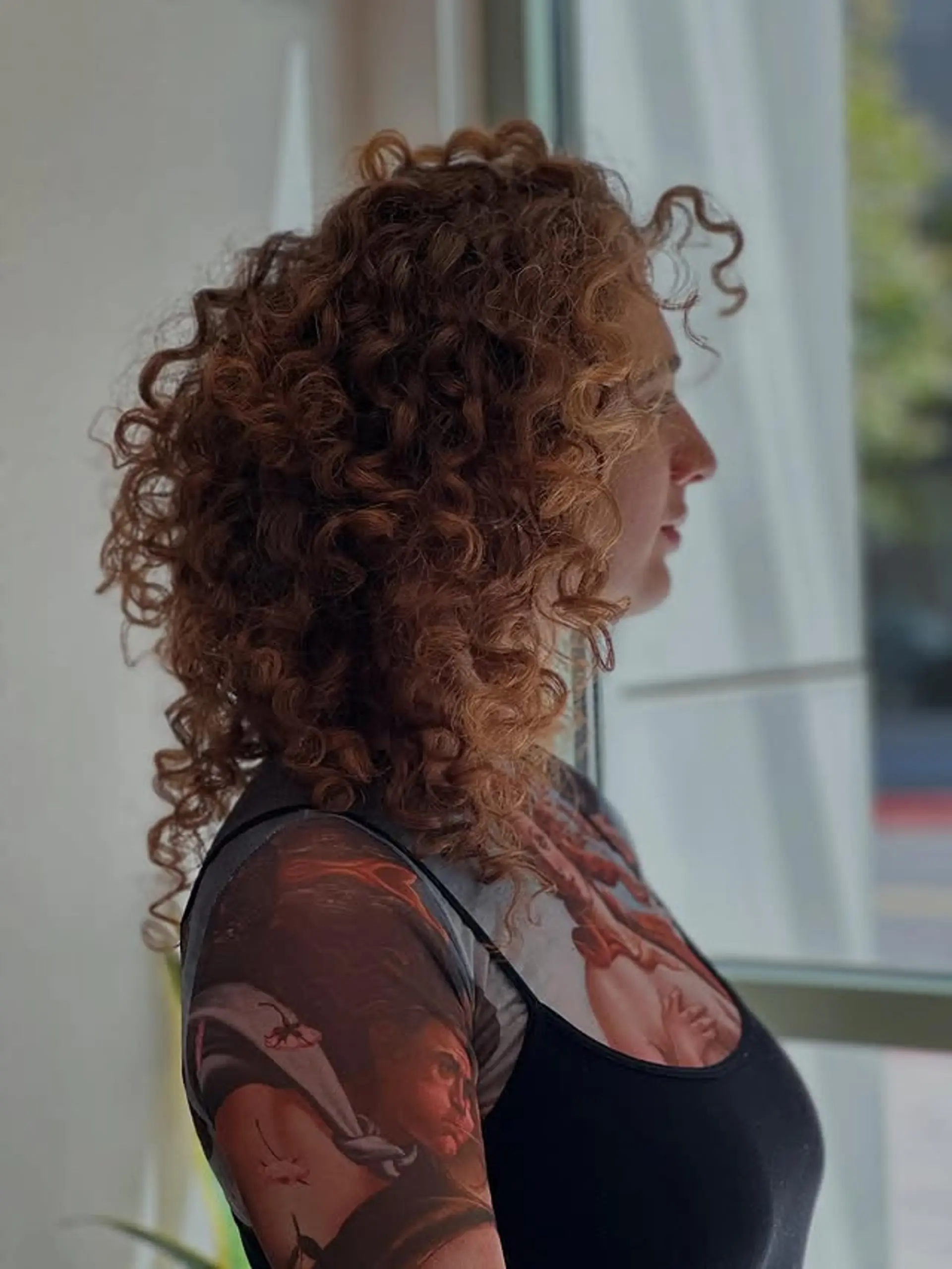 A medium-length curly bob with voluminous natural curls. 1