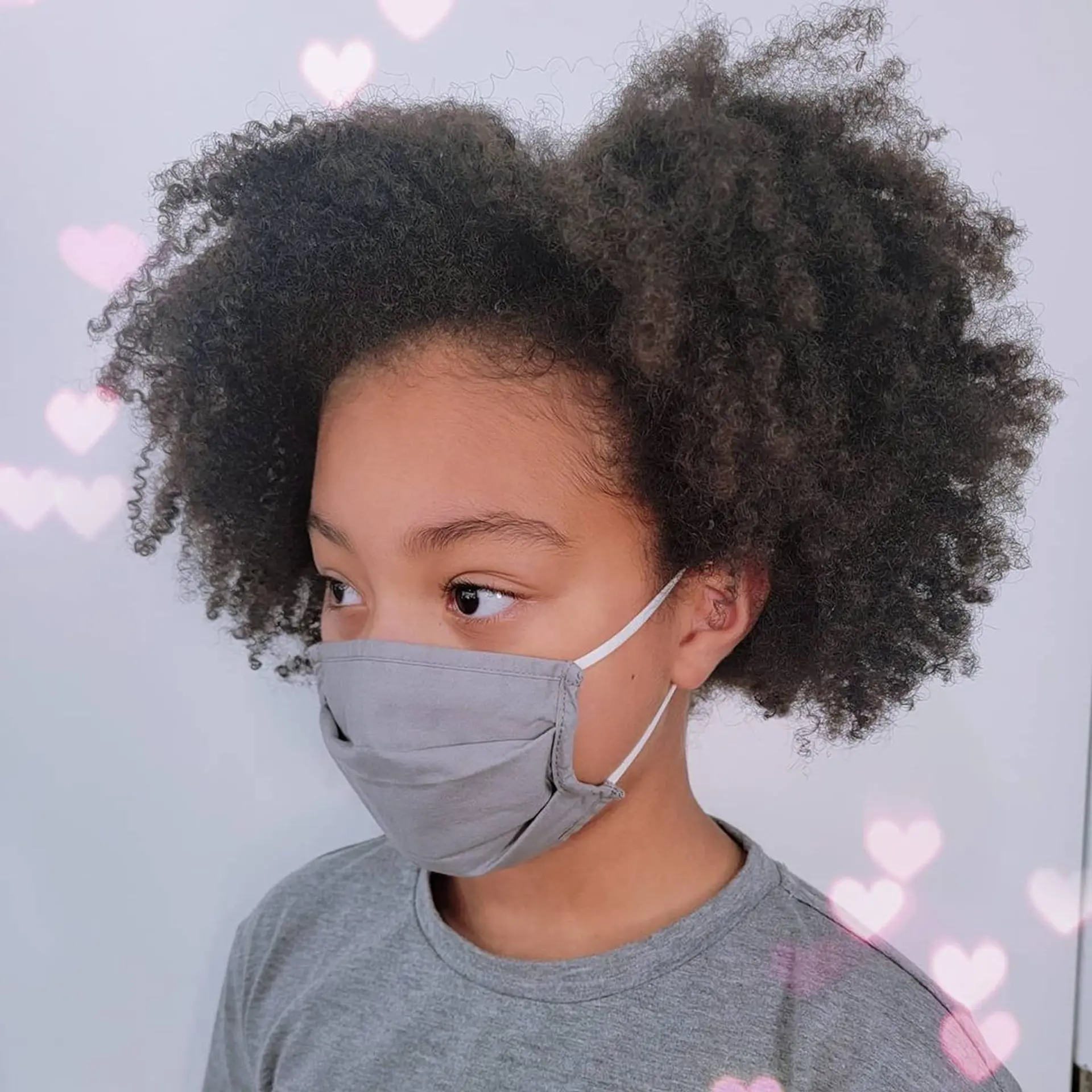 A medium-length, naturally coiled hairstyle with full volume, rounded shape, and soft texture. 1