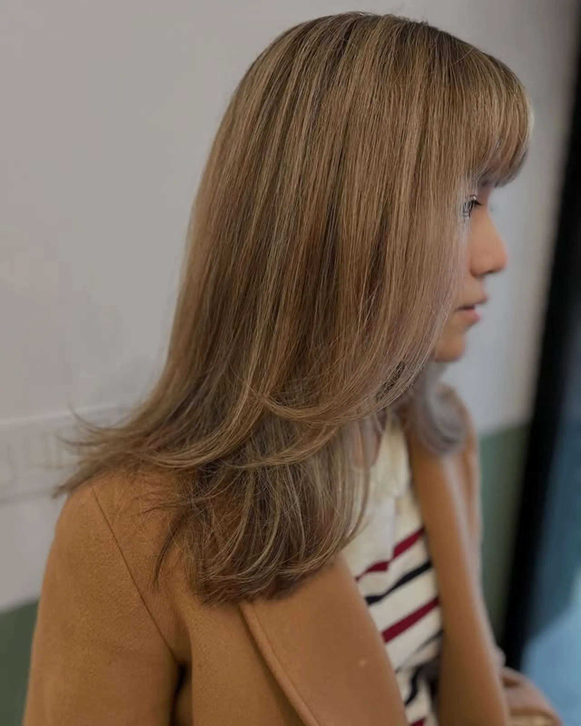 A trendy layered lob with face-framing layers and a soft fringe. 1