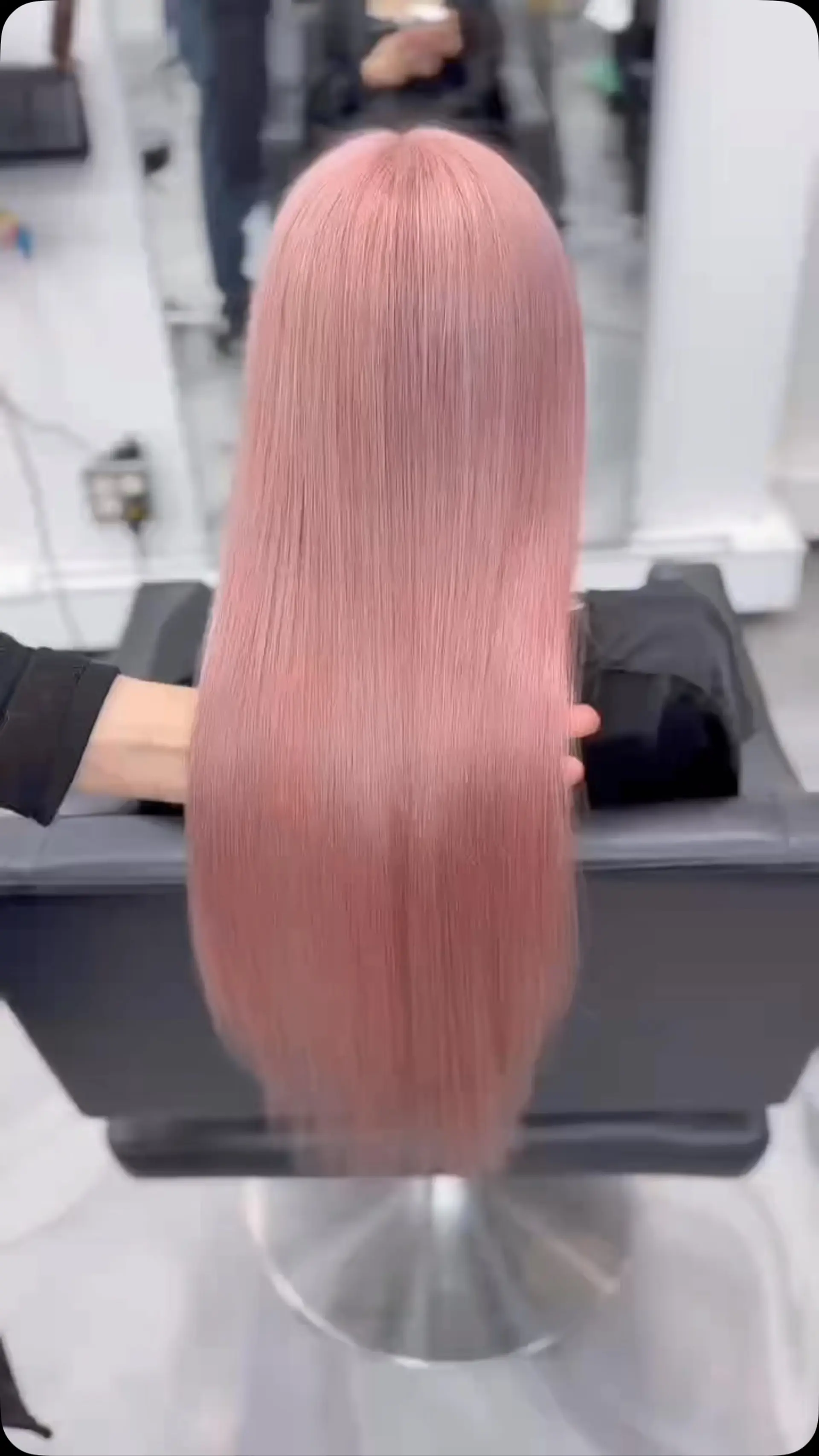 Ultra-sleek, long straight hair dyed in an even, delicate pastel pink shade. 1