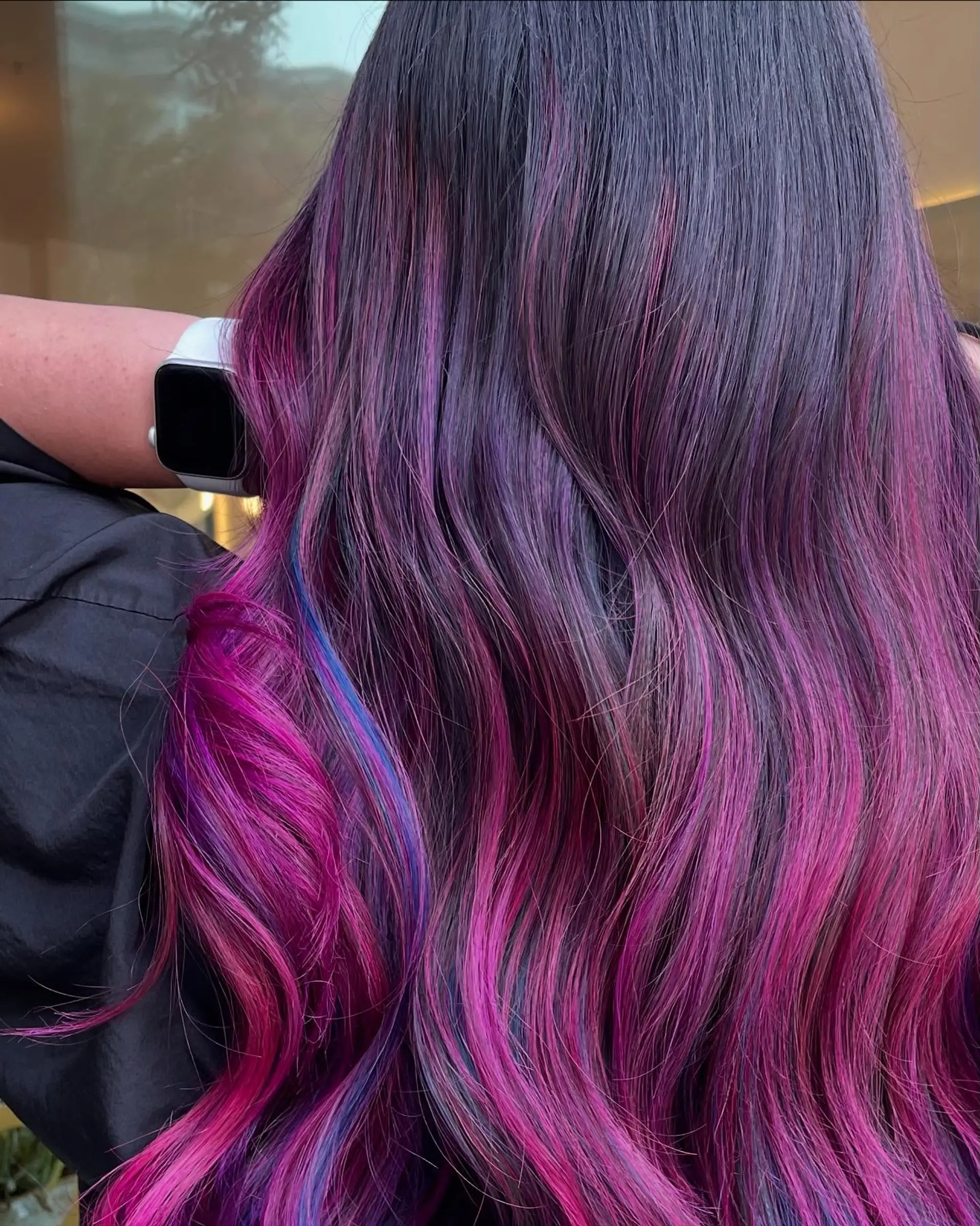 Long dark hair styled in soft waves featuring vibrant ribbons of magenta, purple, and blue throughout. 1