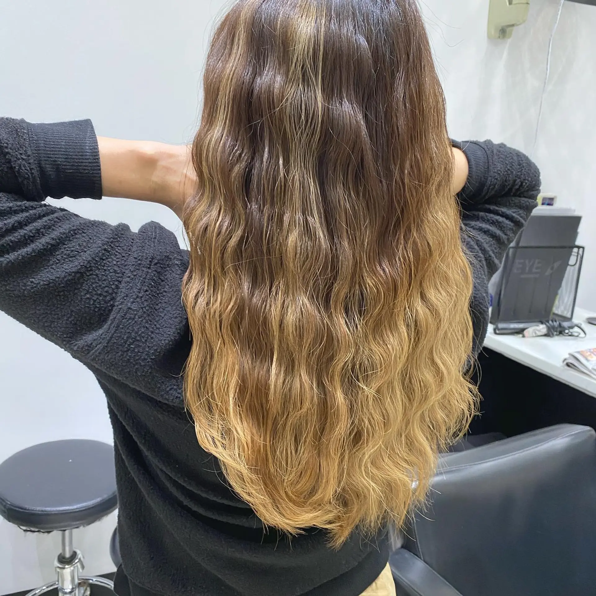 Long, wavy hair with an ombre color effect creating a beachy, textured style. 1