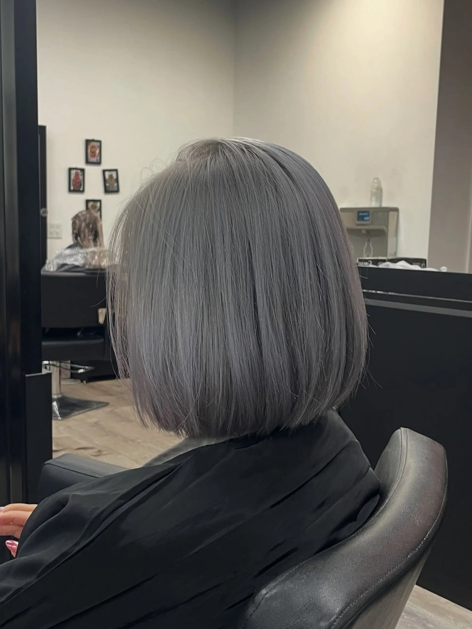 A sleek, chin-length blunt bob with a cool icy grey color. 1