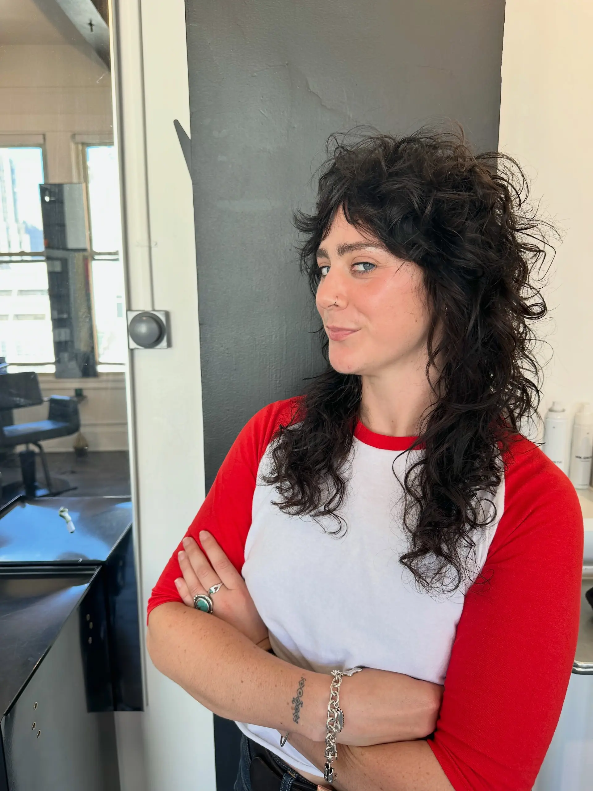 A heavily textured curly shag mullet with choppy crown layers and textured bangs. 1