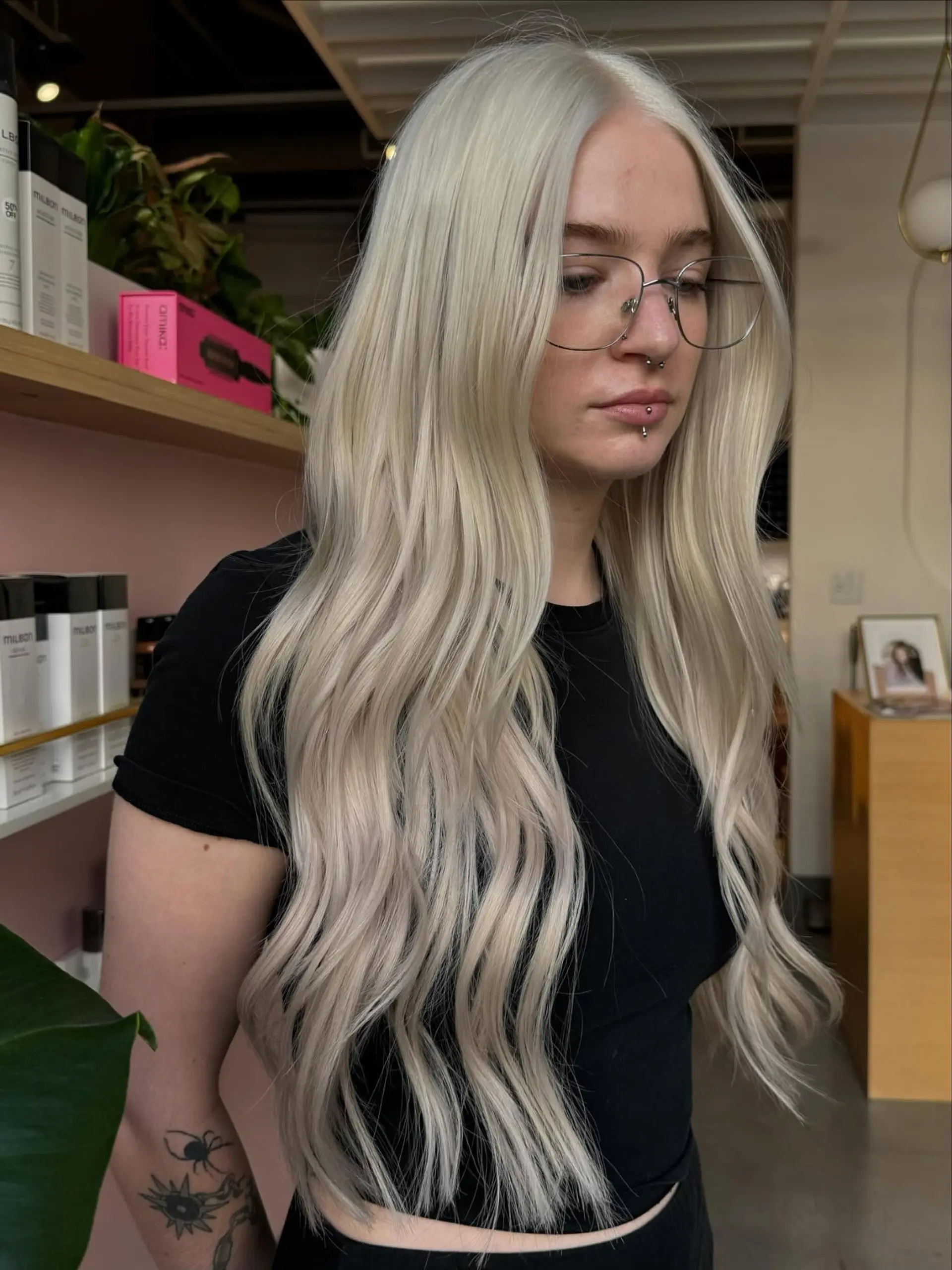 Extra-long icy platinum blonde hair styled with soft, cascading waves and a middle part. 1
