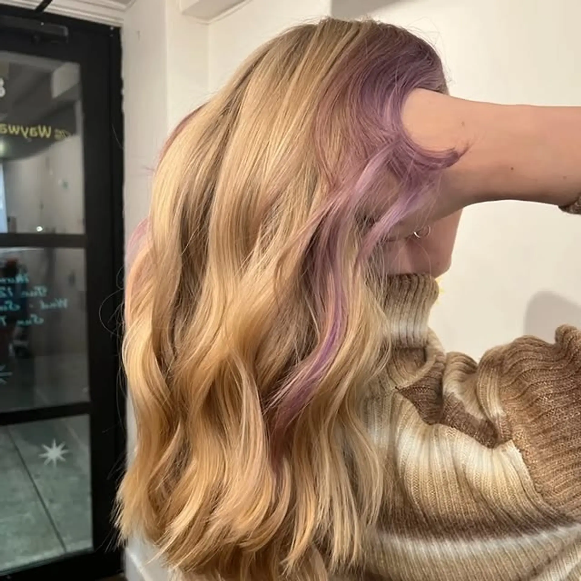 Long, wavy hair with blonde and purple fantasy color accents and money piece highlights. 1