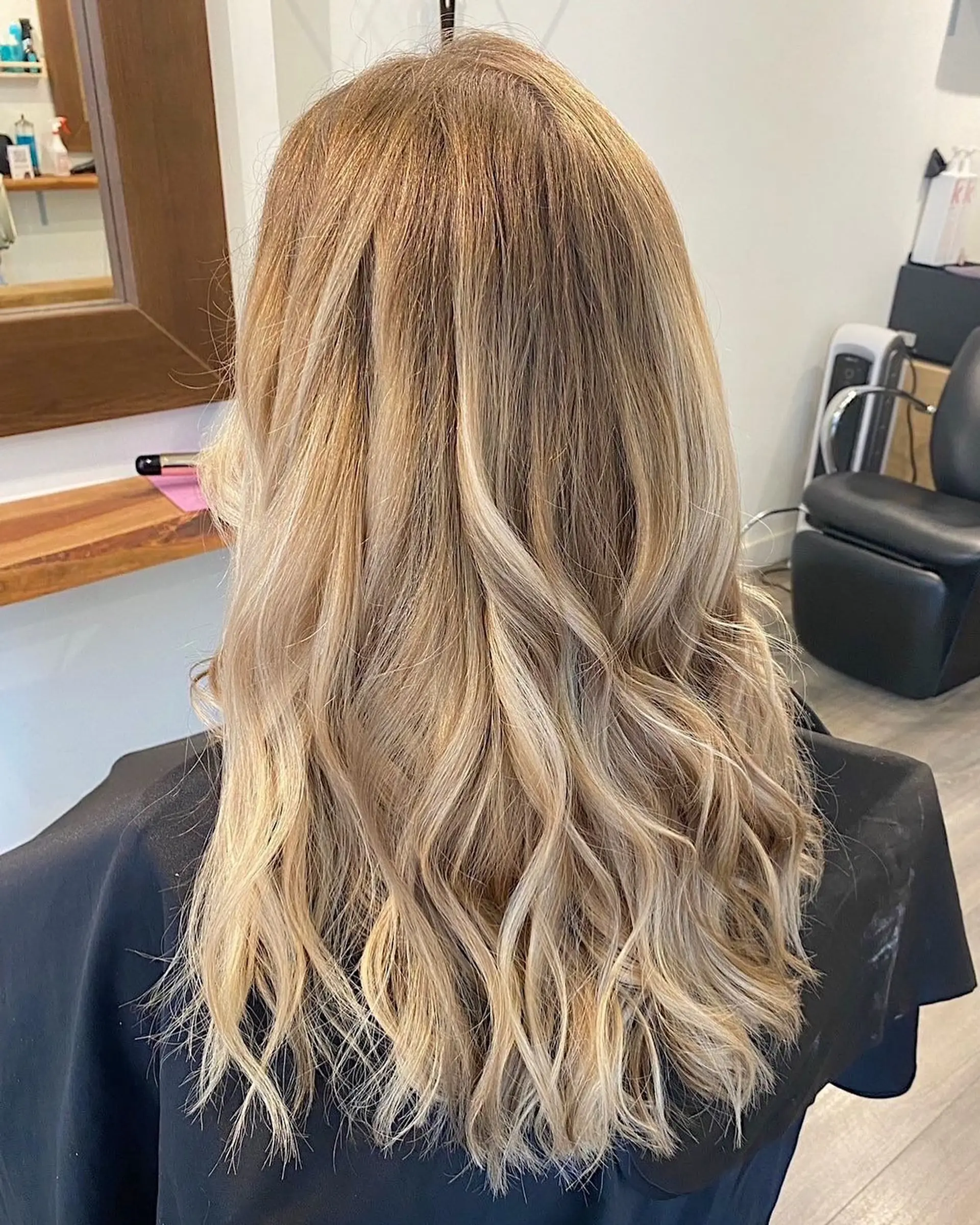 Long, wavy hairstyle with golden blonde balayage. 1