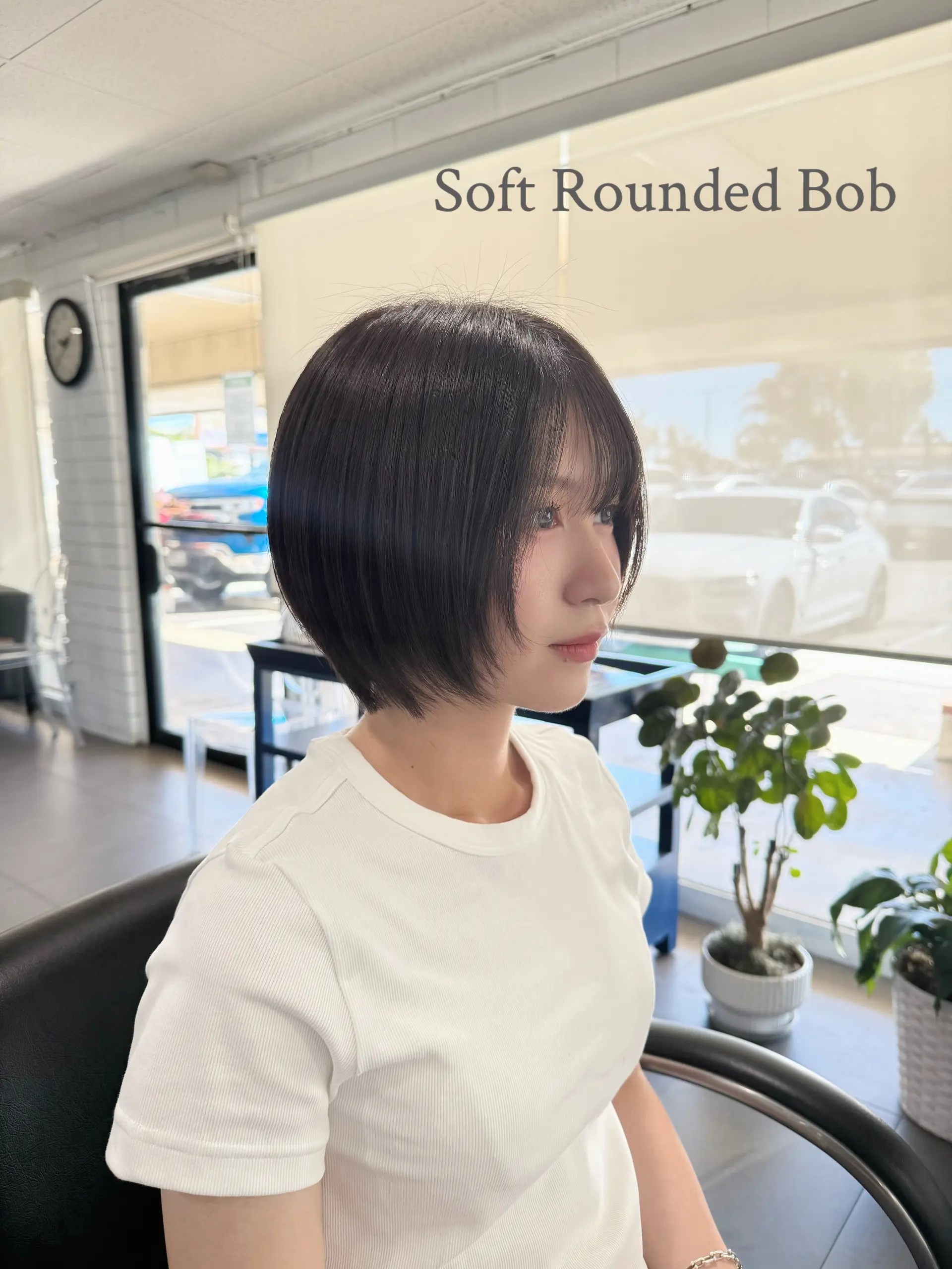 A soft rounded short bob with subtle face-framing layers and wispy see-through bangs. 1