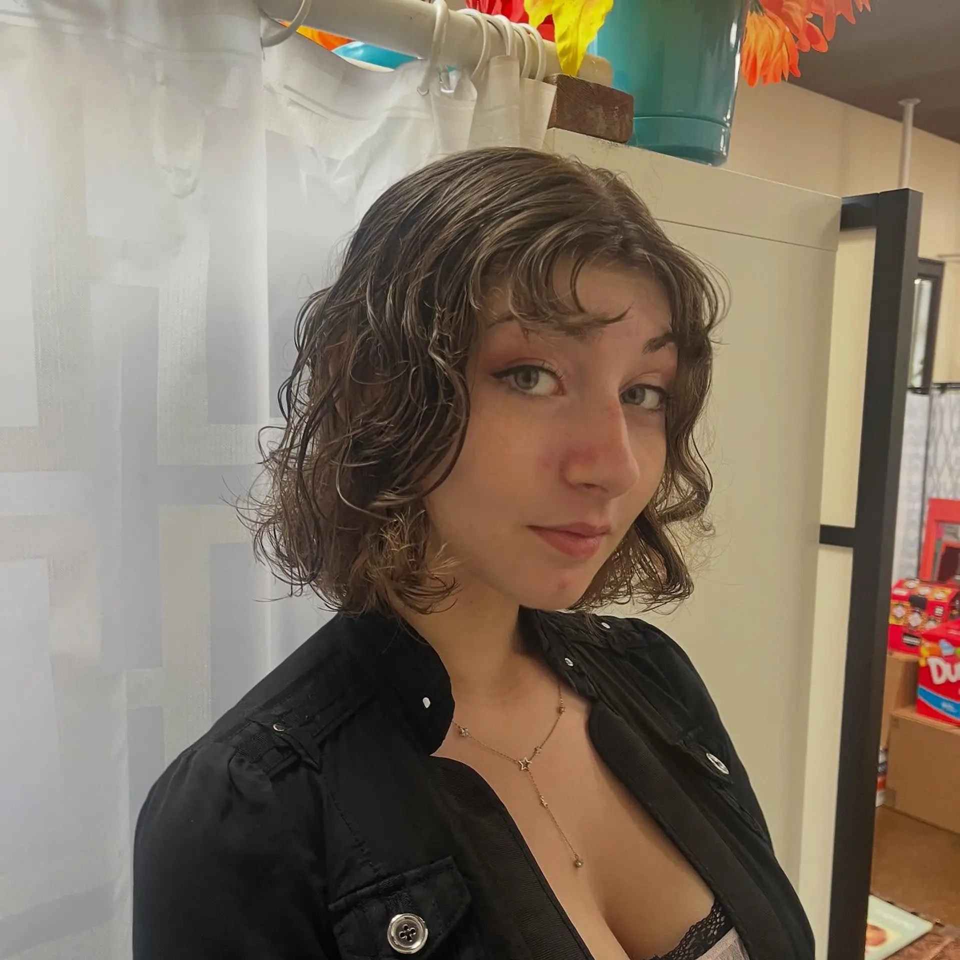Chin-length textured wavy bob haircut styled with soft, piecey curly fringe bangs. 1