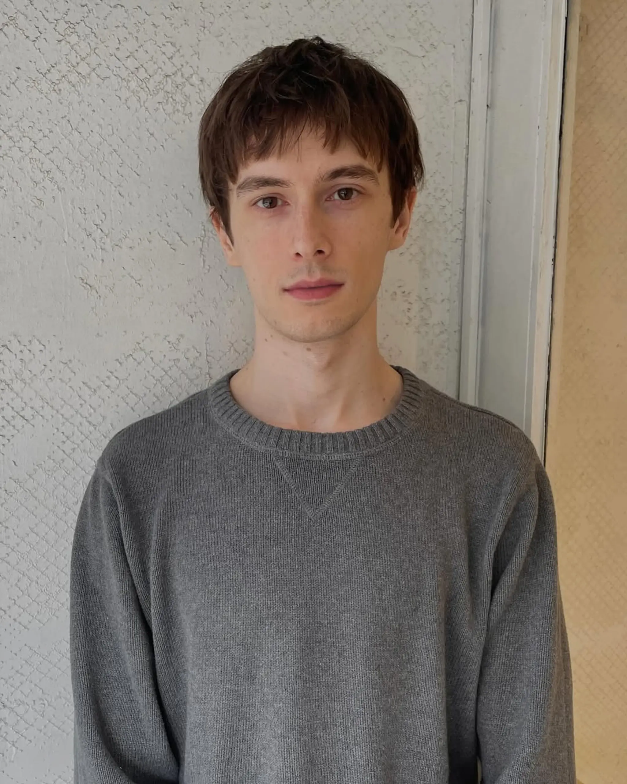 A medium-length, straight hairstyle with textured layers and a soft, natural fringe.