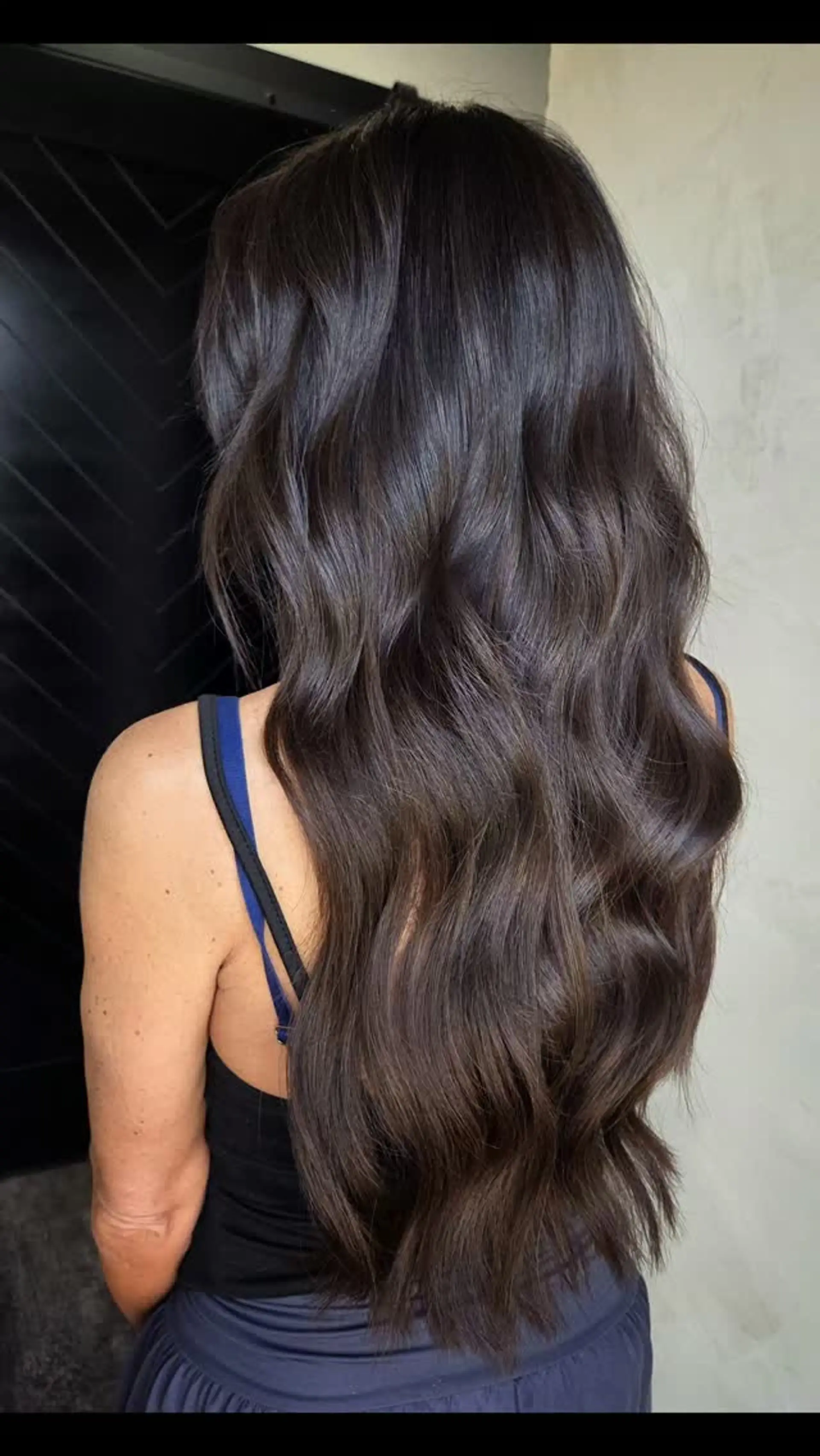Extra-long chocolate brunette hair styled in loose, glossy waves with soft, subtle dimension. 1