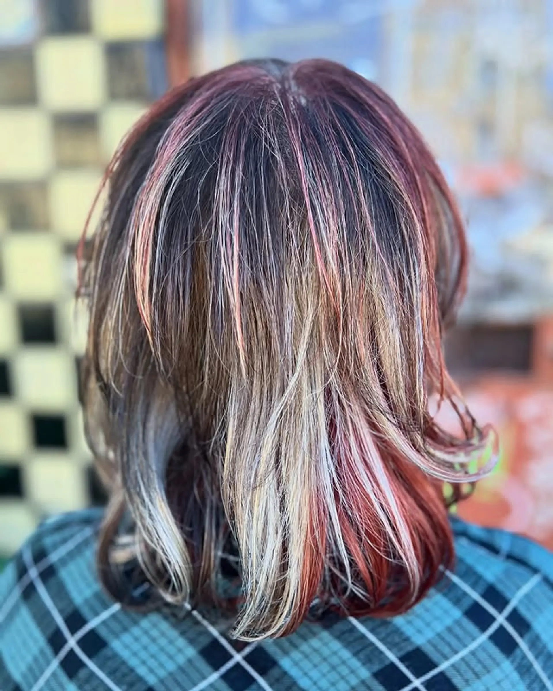 A layered bob with rainbow streaks in vibrant colors. 1