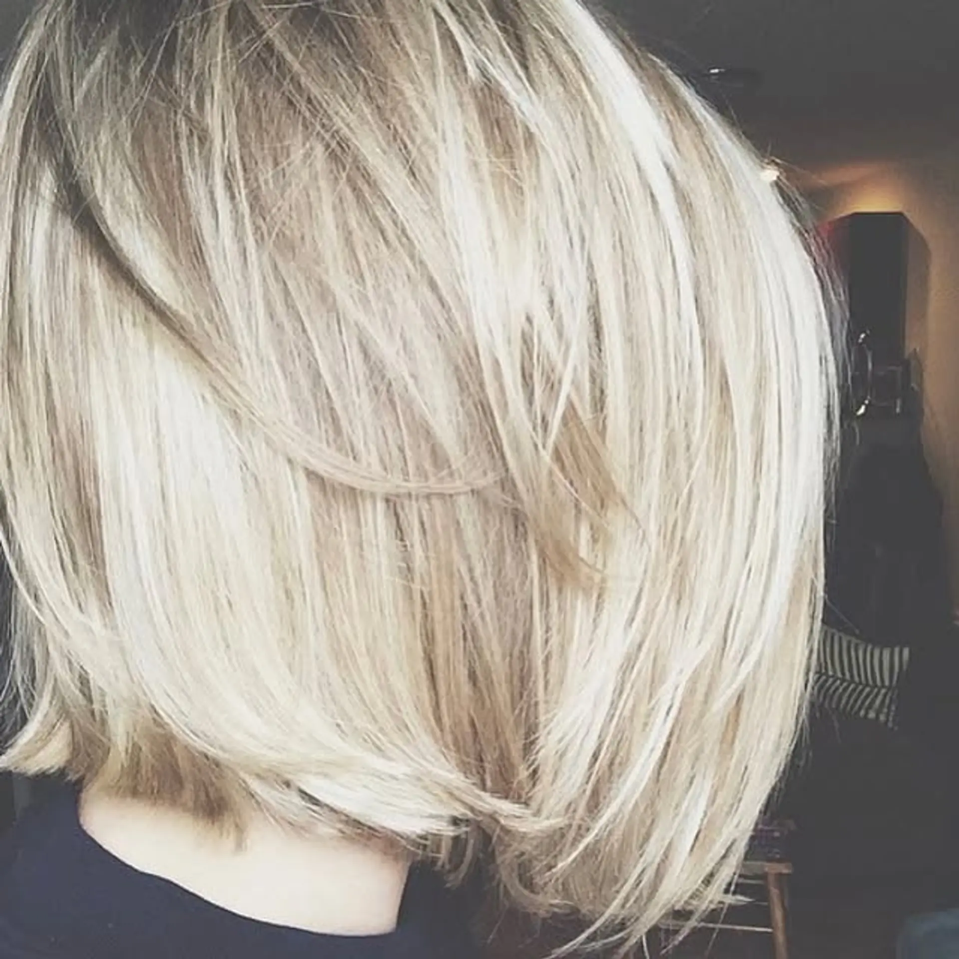 A stylish, short layered bob haircut with subtle layers for added movement and texture. 1