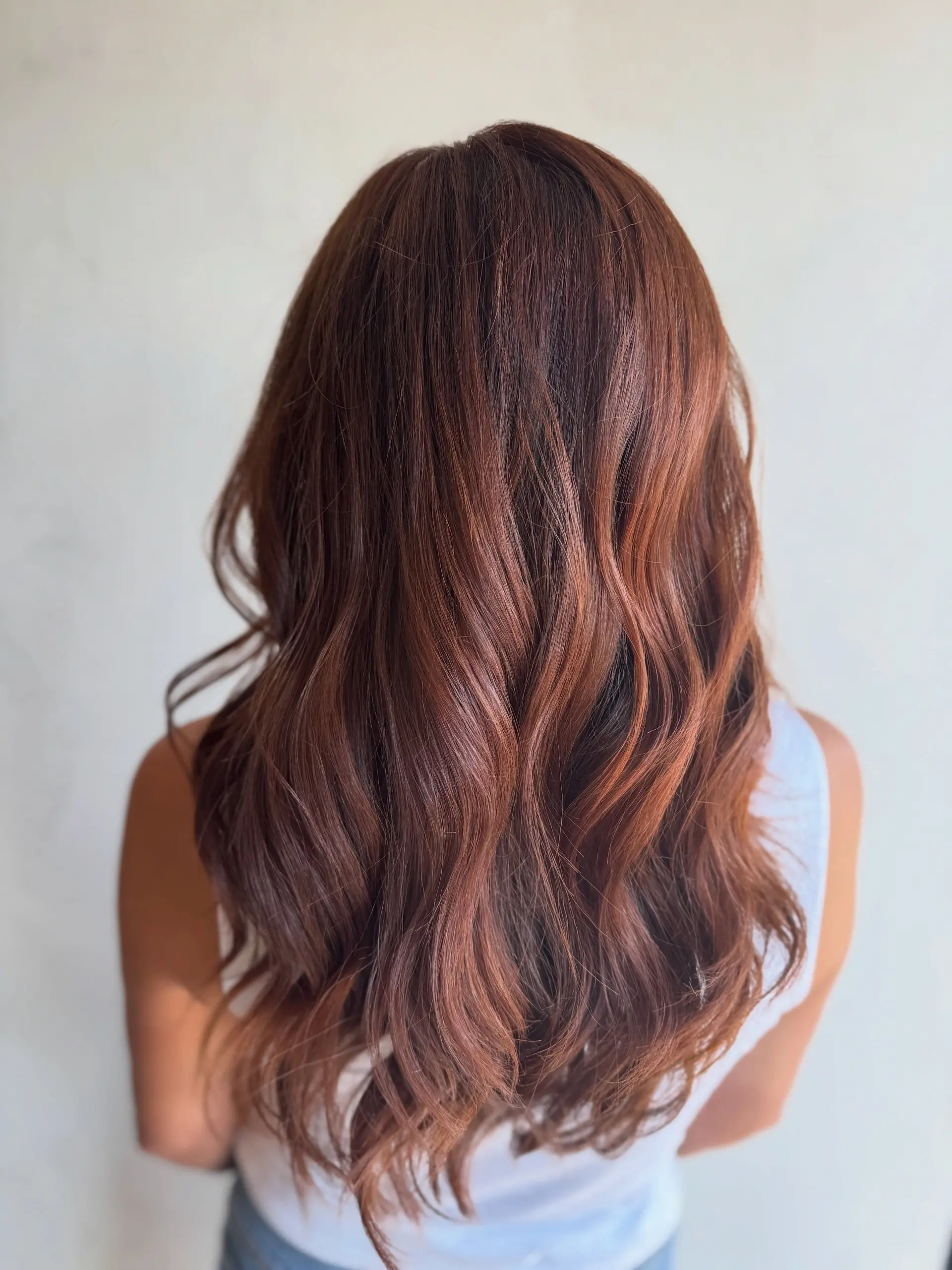 Long, dimensional cinnamon copper hair styled in soft, cascading waves. 1