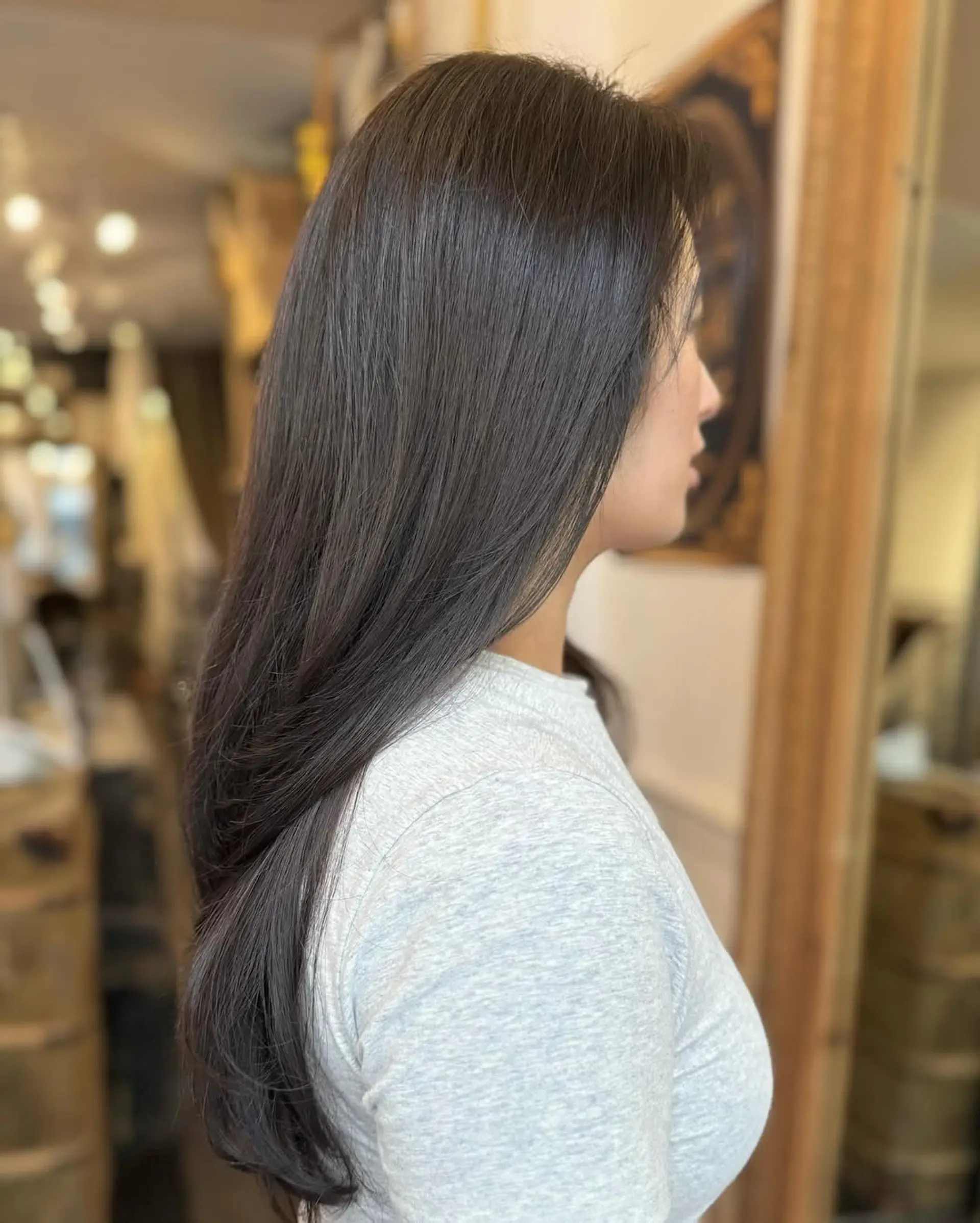 Long, layered, dark brown wavy hair with voluminous face-framing strands. 4