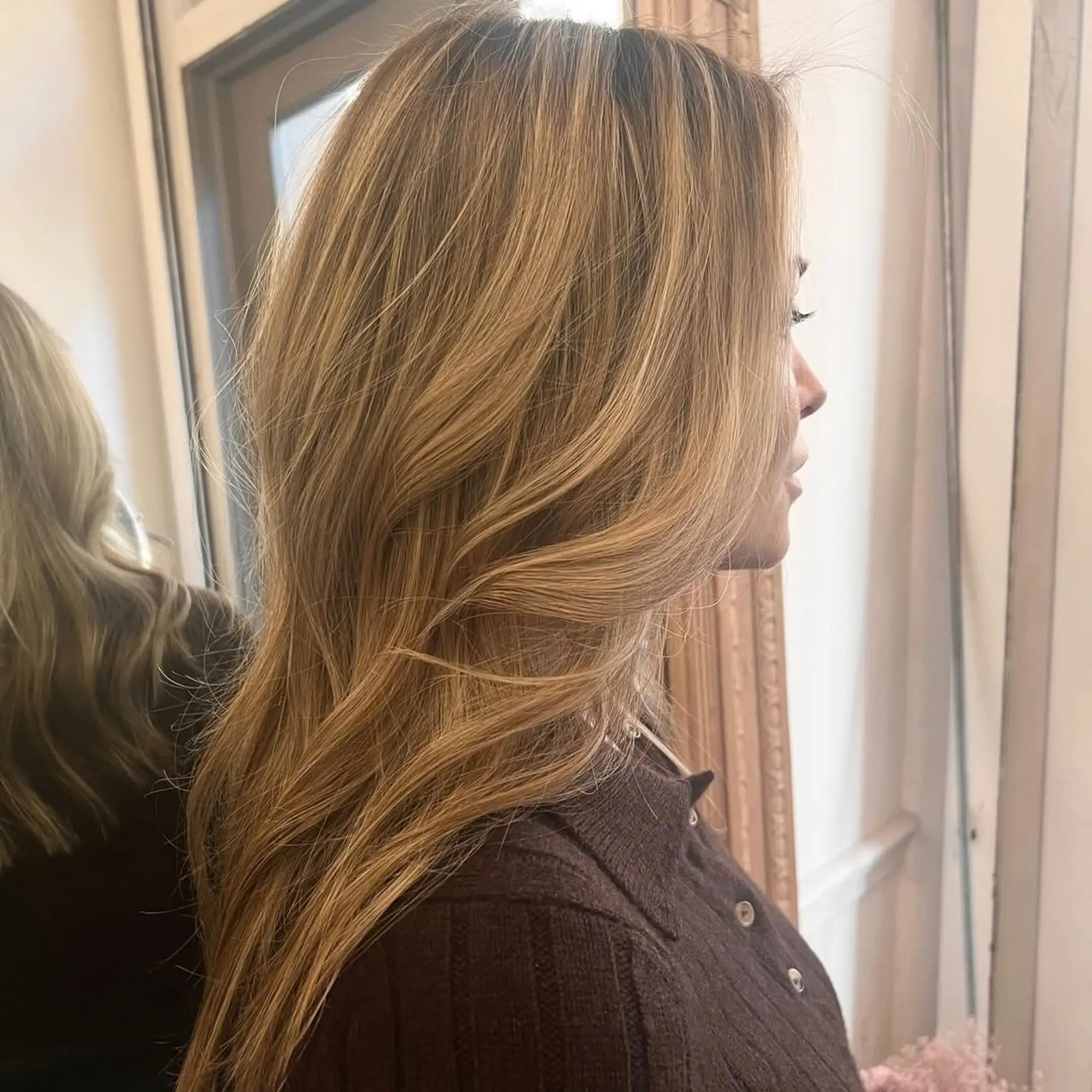 Long, wavy blonde hair with a side part, layered cut, and face-framing layers. 1