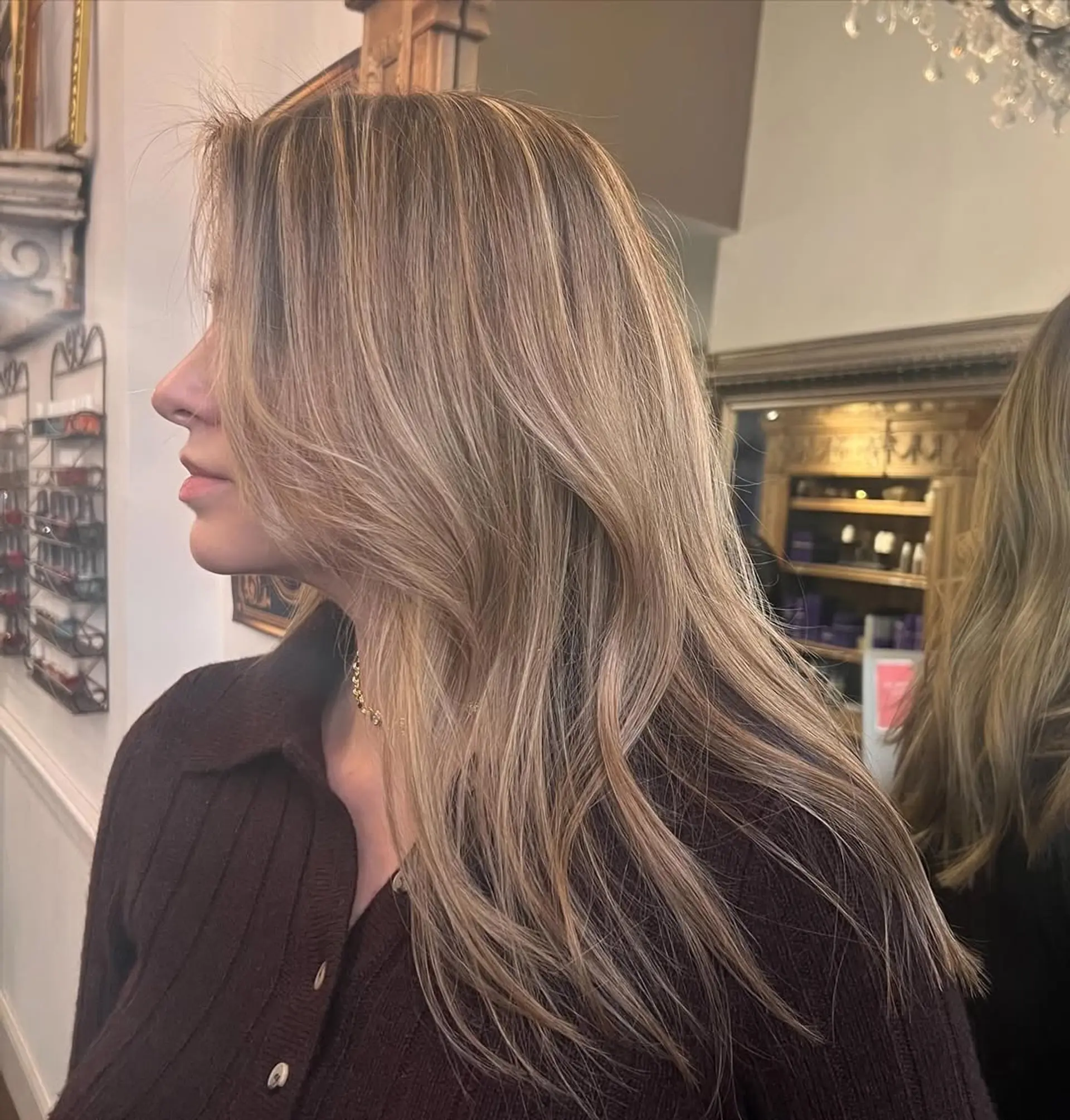 Long, wavy blonde hair with a side part, layered cut, and face-framing layers. 2