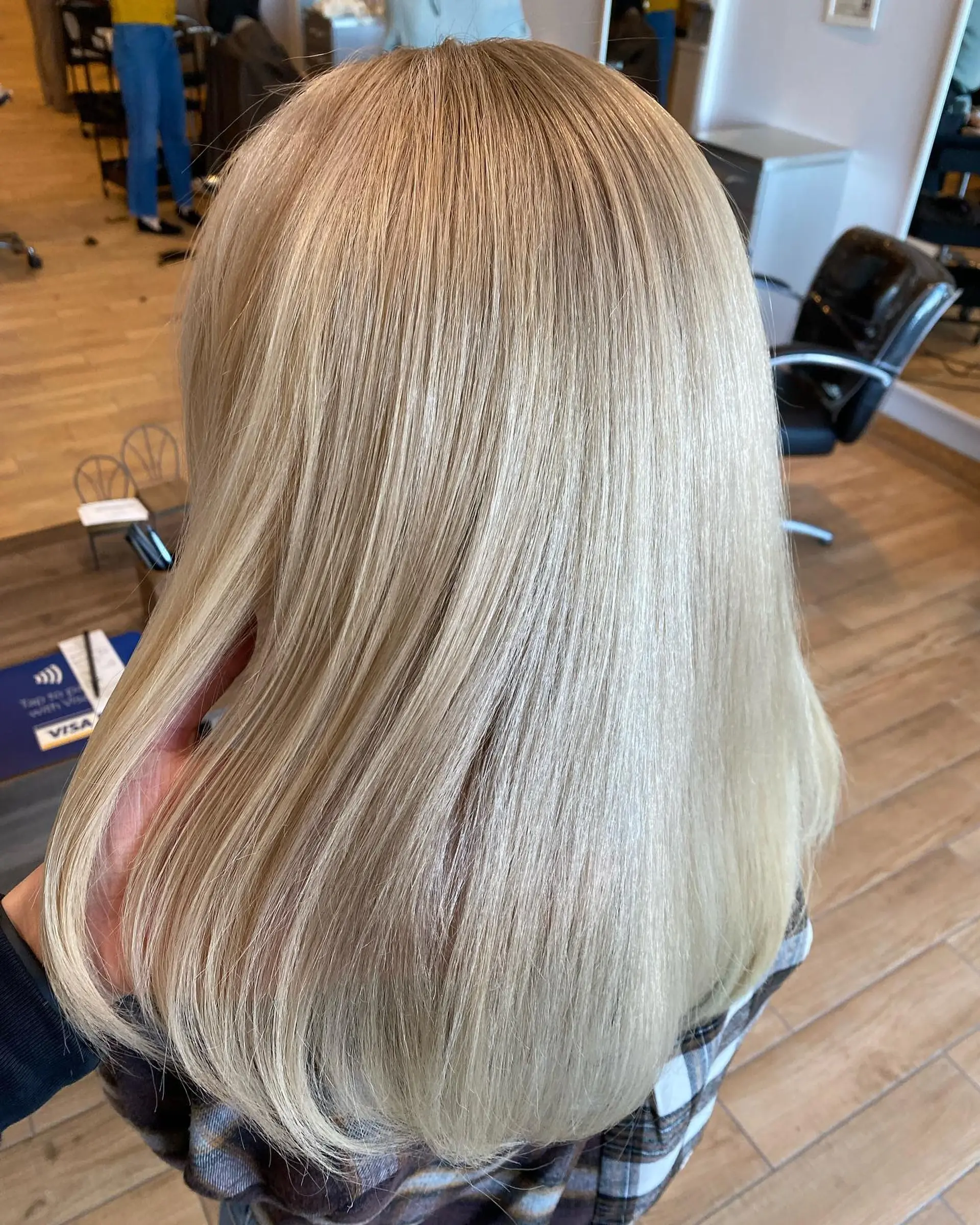 A sleek, smooth medium-length hairstyle featuring a full bleach out to a cool platinum blonde tone. 1
