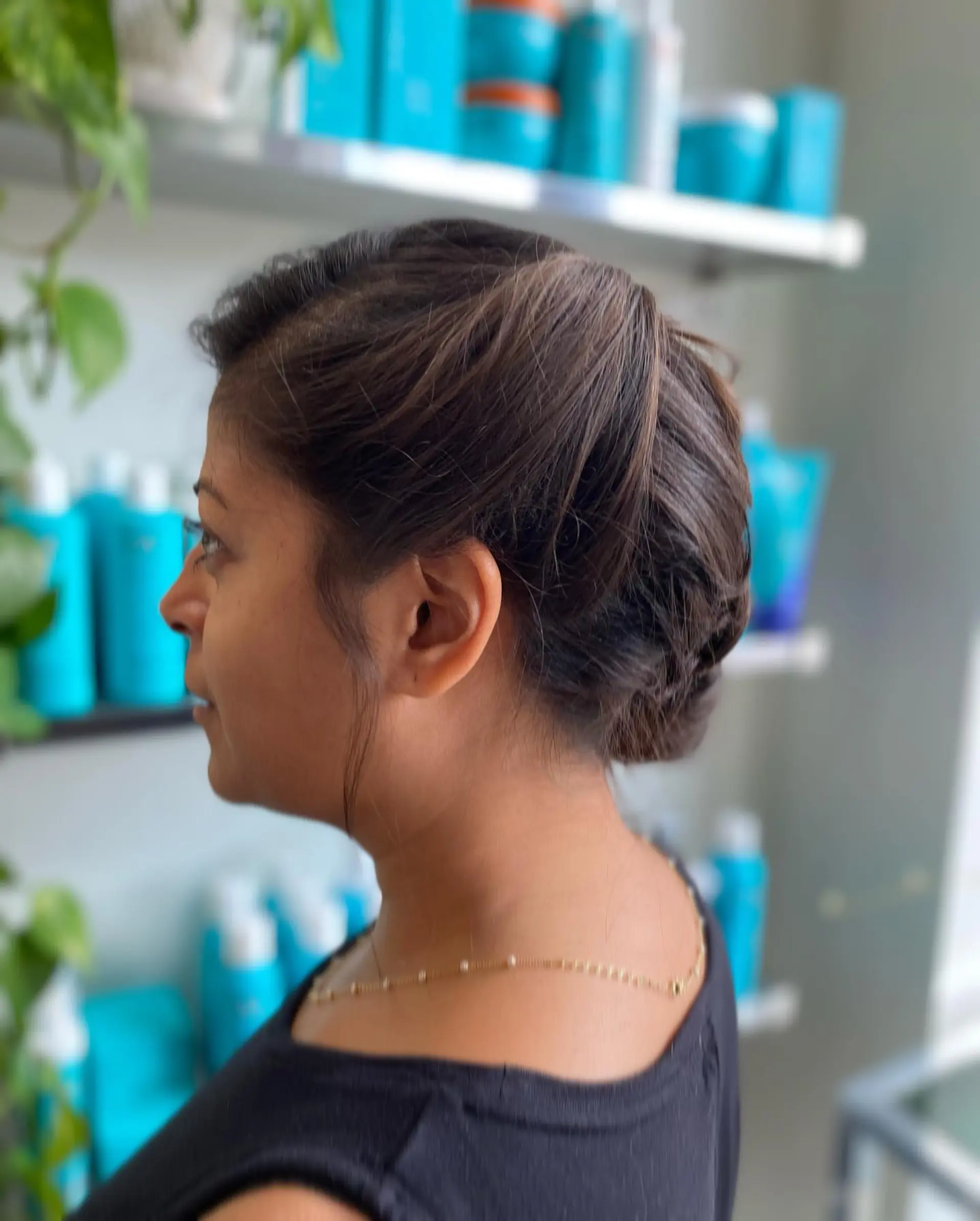 A sophisticated, voluminous bridal updo smoothly gathered at the back of the head into a low textured chignon. 1