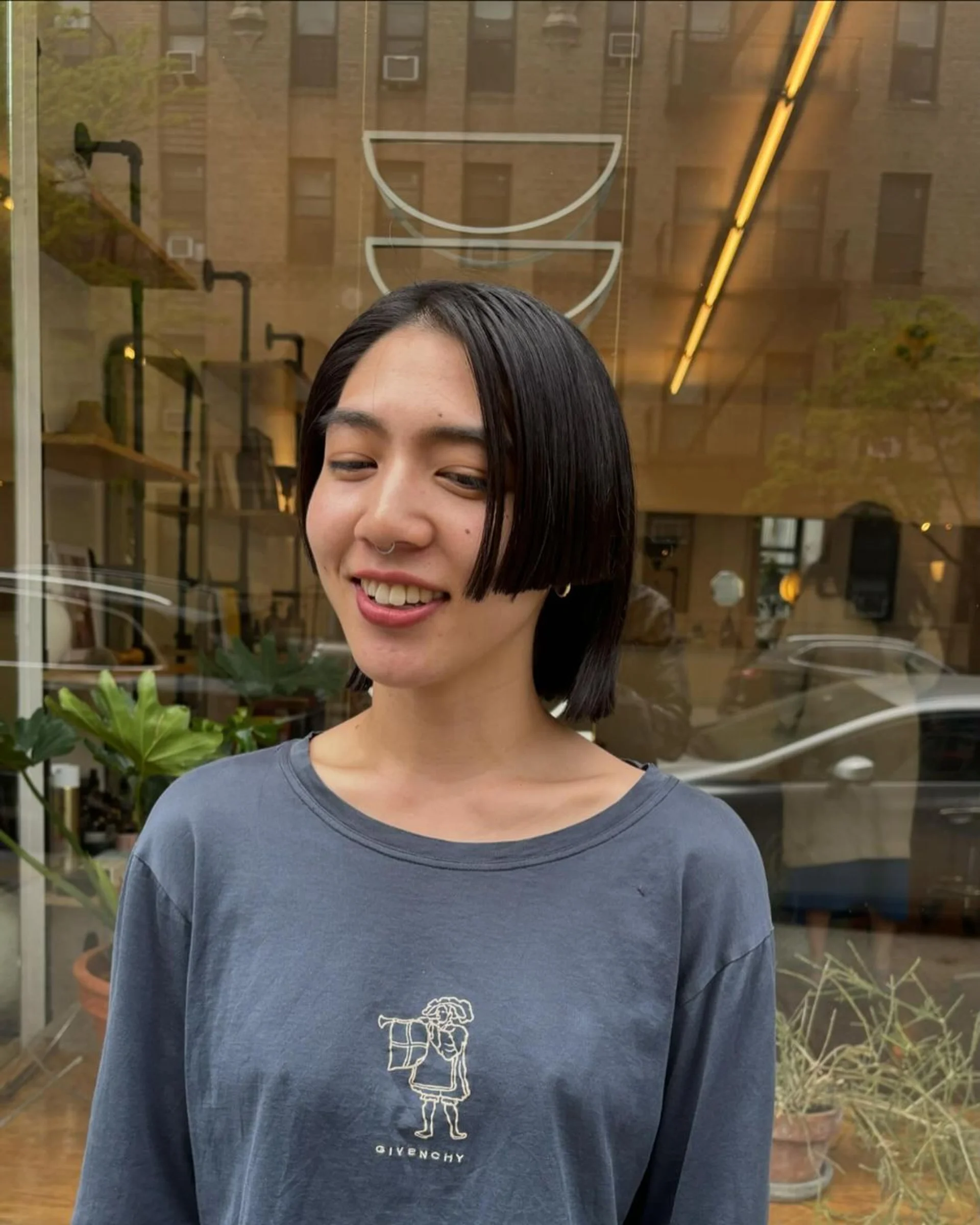 A woman with a sleek, dark brown, sharp bob haircut, a key Winter 2025 hair trend in NYC. - Preview 1