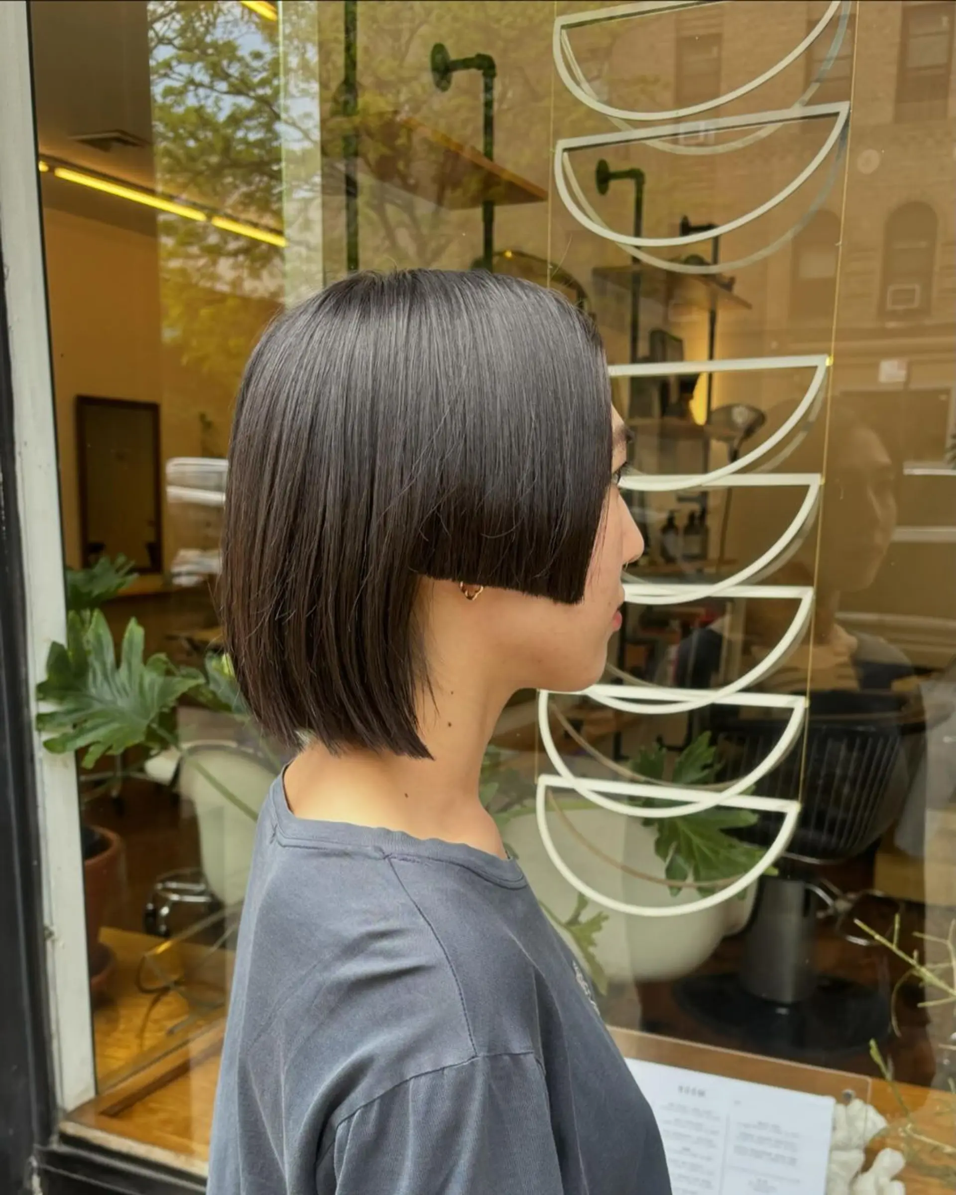 A sleek, asymmetrical bob with sharp edges, chin length, straight texture, and a smooth, polished finish. haircut by @takeohair 2