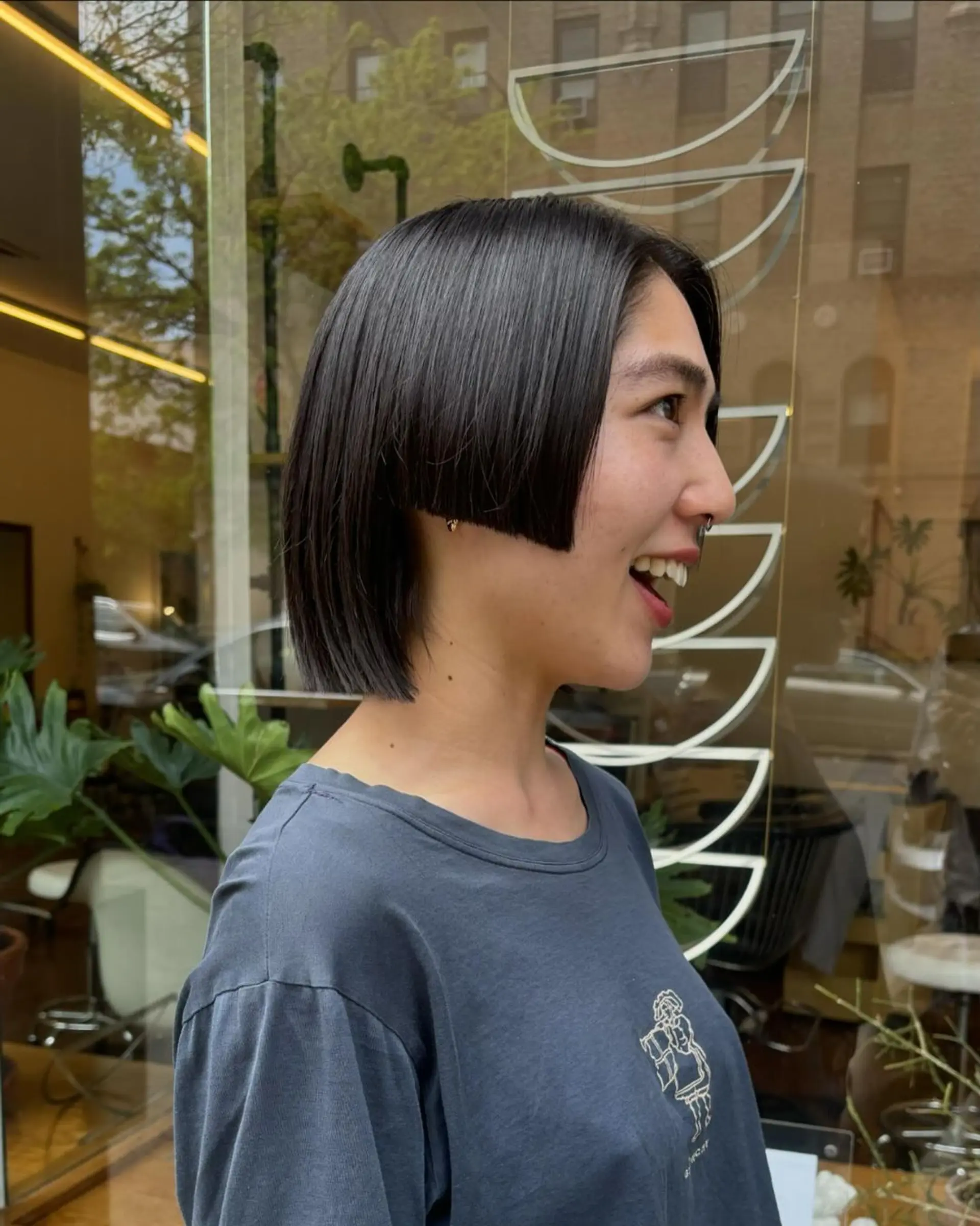 A sleek, asymmetrical bob with sharp edges, chin length, straight texture, and a smooth, polished finish. haircut by @takeohair 1