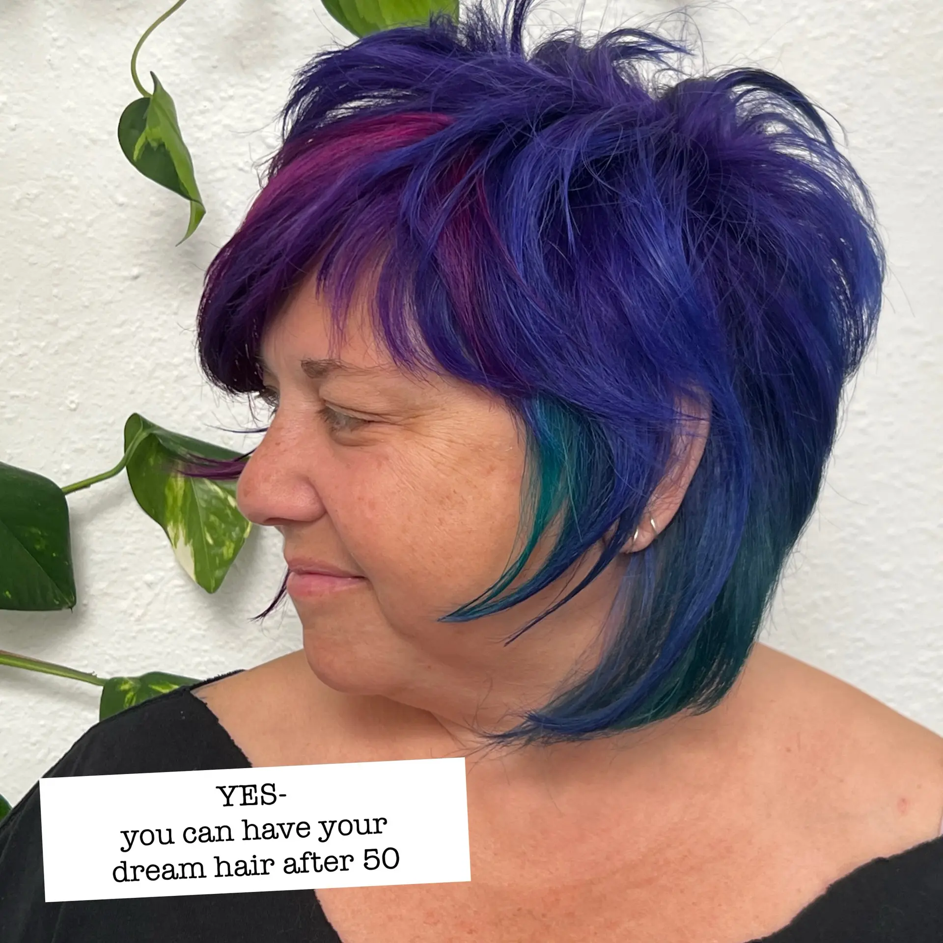 A choppy short pixie bob styled with piecy texture and bold vivid tones of purple, magenta, and teal. 1