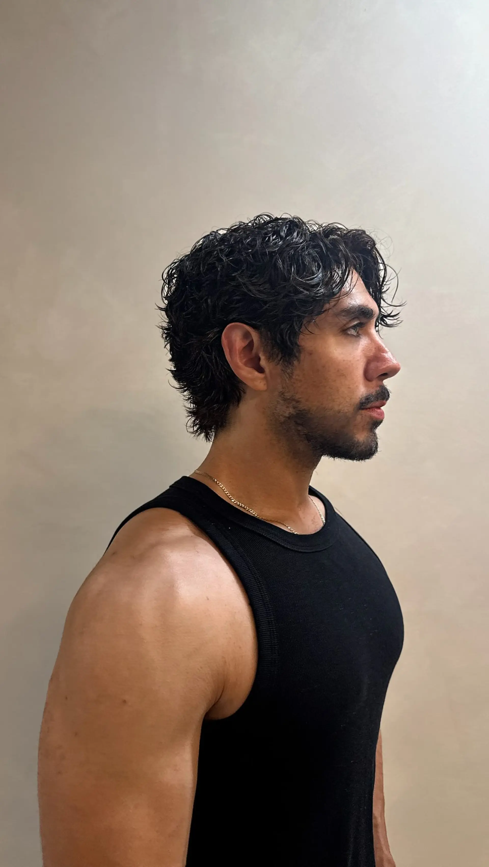 A men's short haircut featuring customized soft, natural wave perming with reduced side volume and textured curls. 1