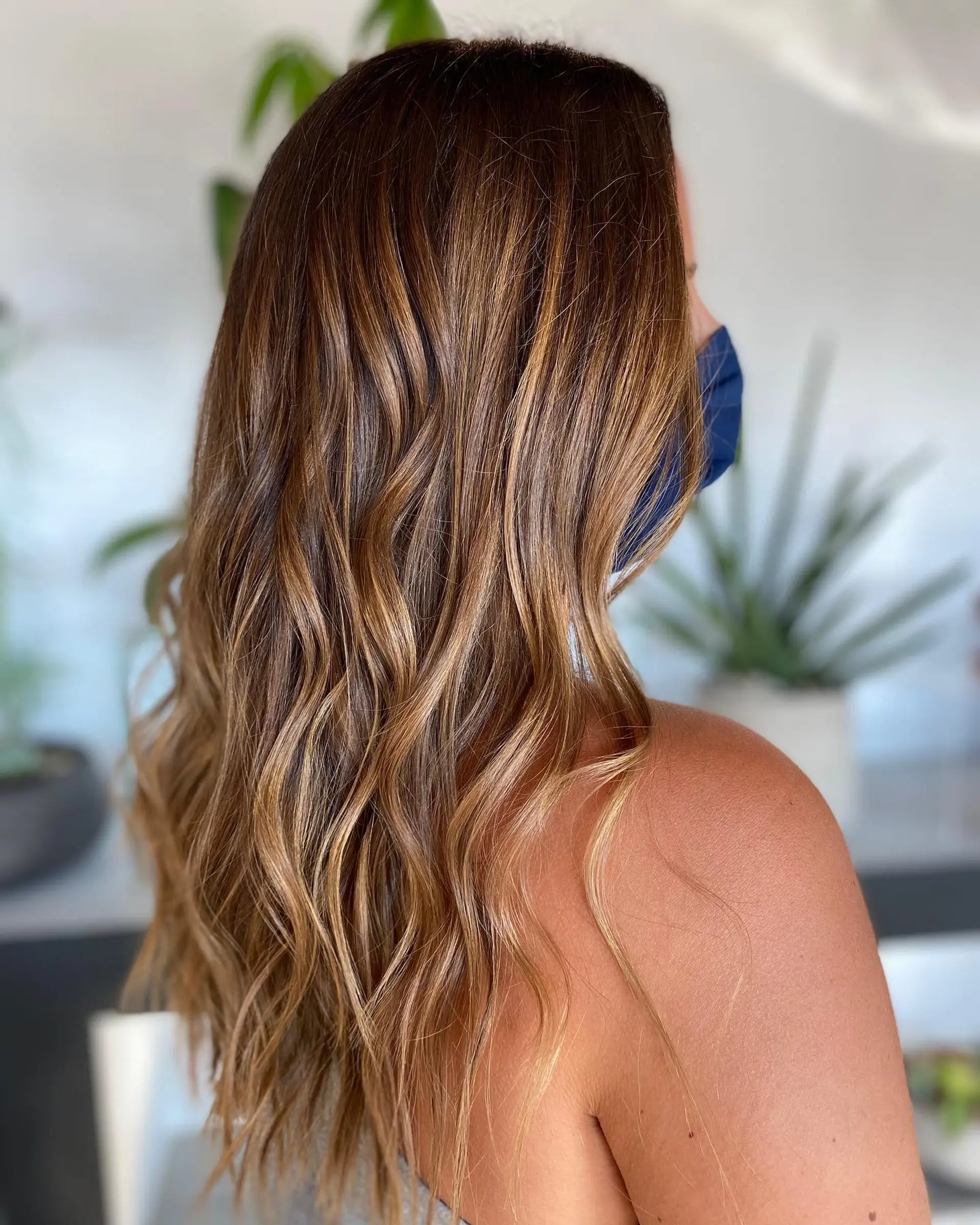 Long warm honey and caramel balayage styled into effortless, soft waves. 1