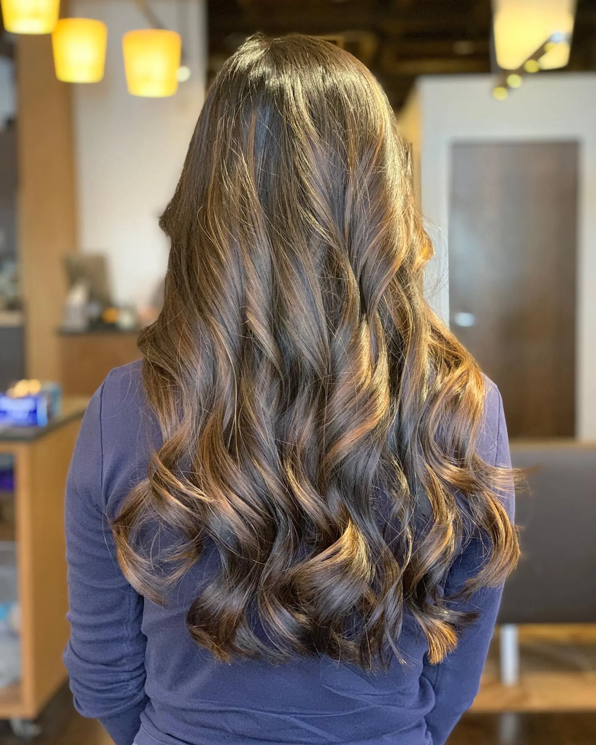 Long, layered waves with a soft, face-framing balayage. 3