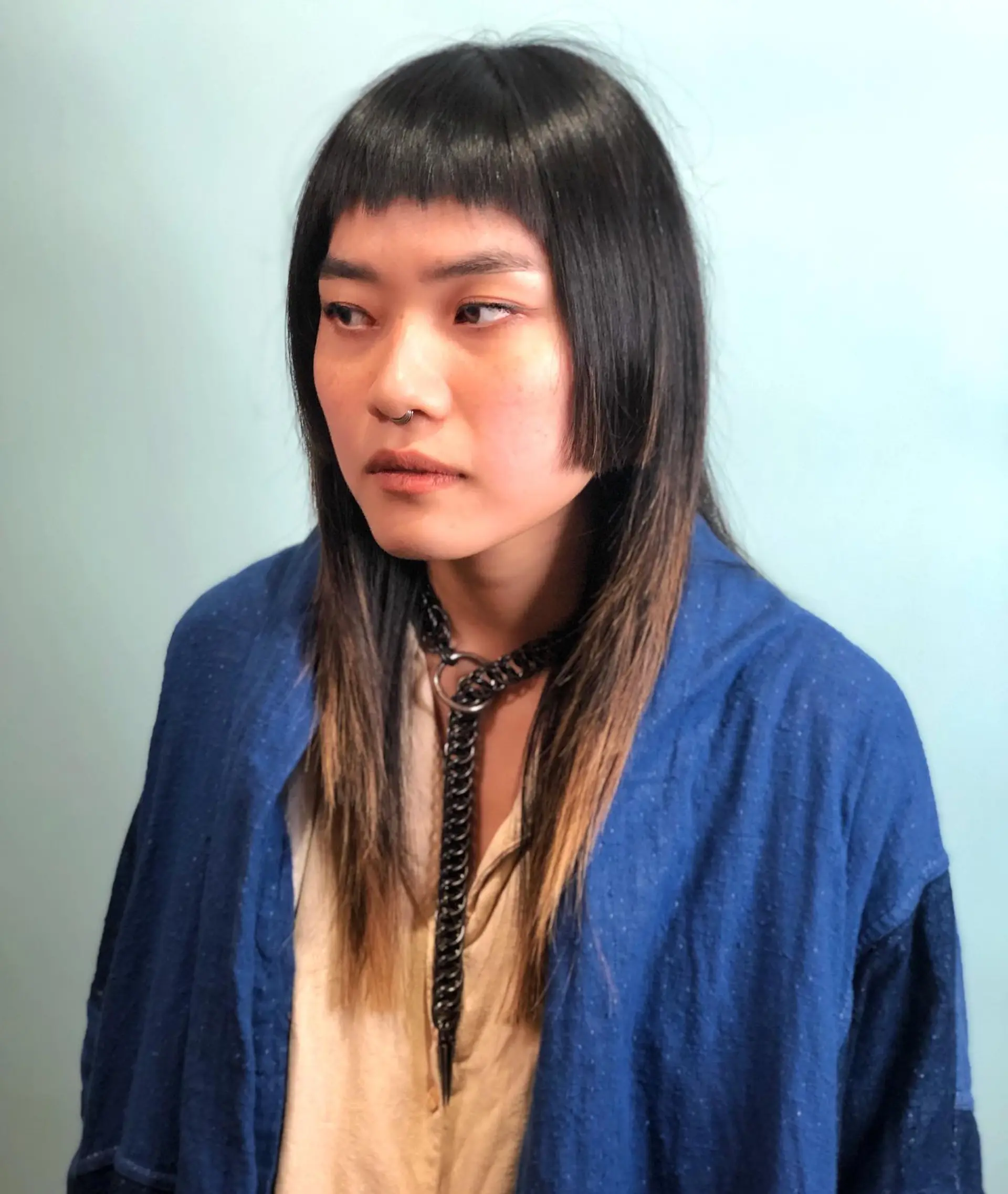 A modern shag haircut with baby bangs and face-framing layers for an edgy and stylish look. 1